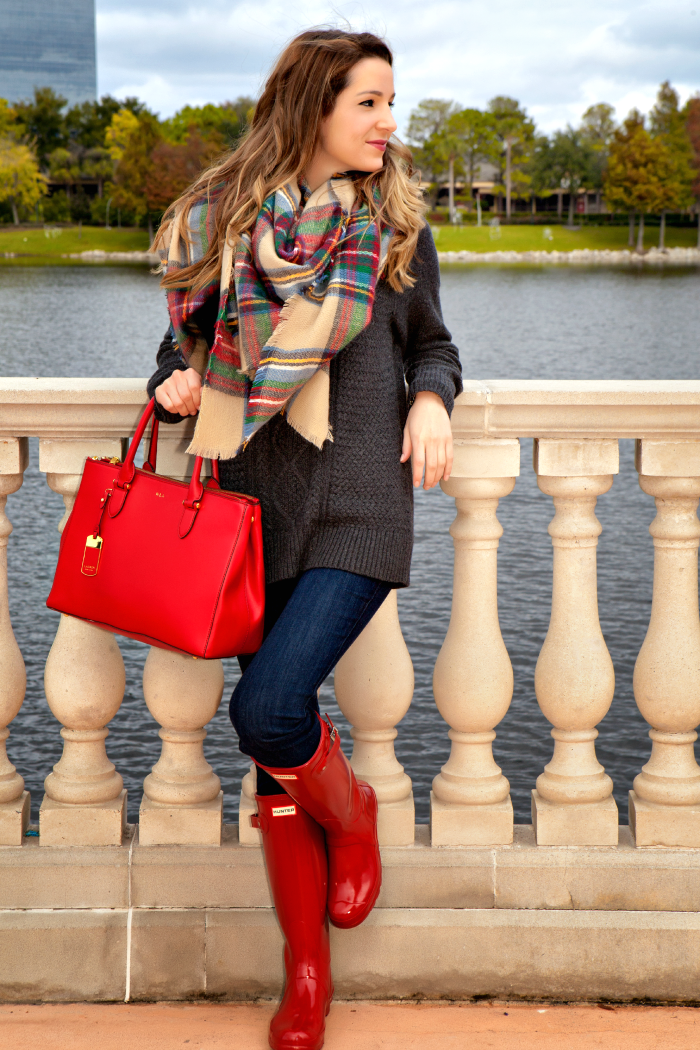 Chunky cable knit sweater, tartan blanket scarf, and red hunter boots outfit styled by affordable fashion blogger Stephanie Ziajka on Diary of a Debutante