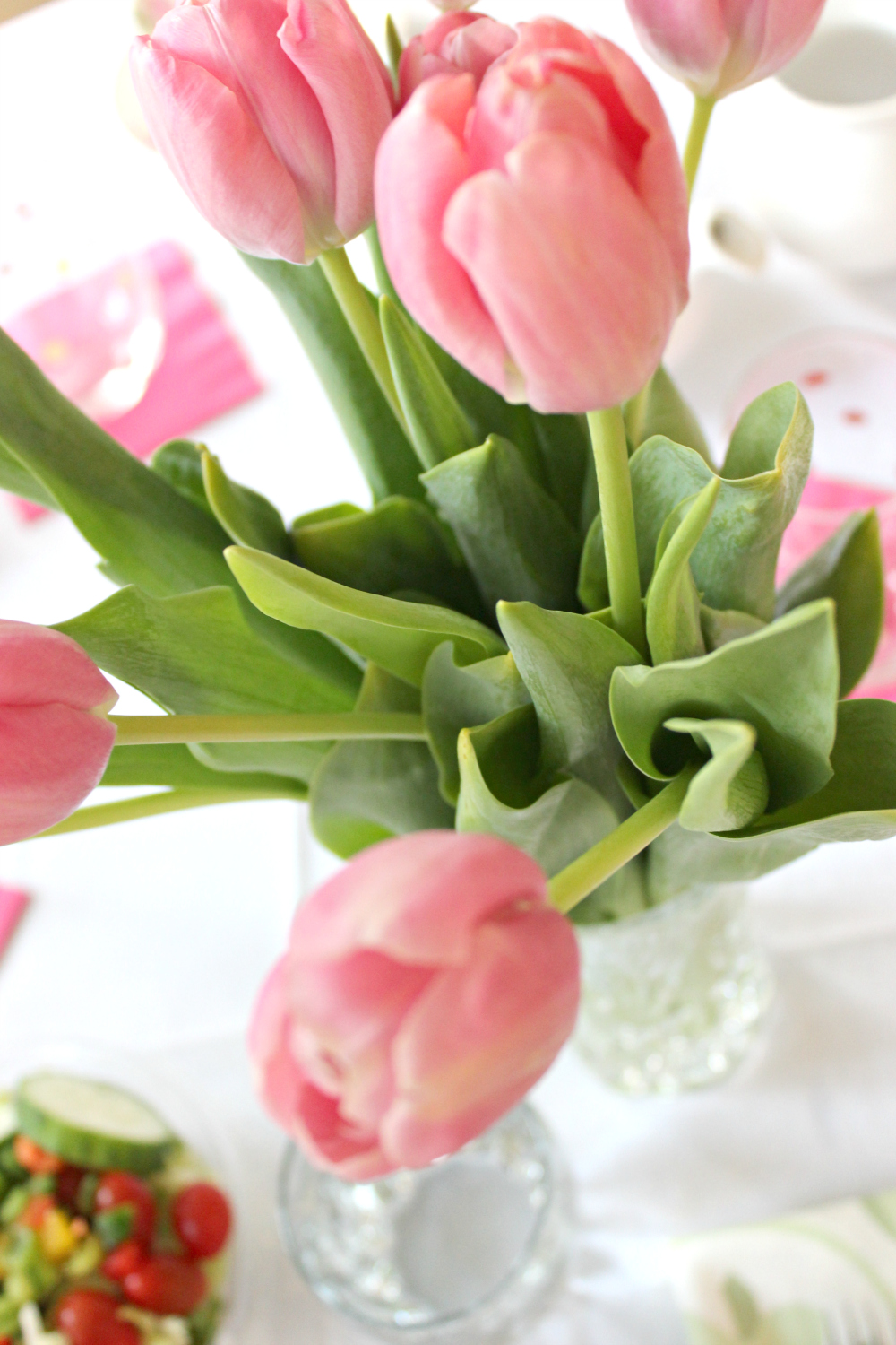 Pink tulips in a vase in a pastel tablescape designed by southern lifestyle blogger Stephanie Ziajka on Diary of a Debutante
