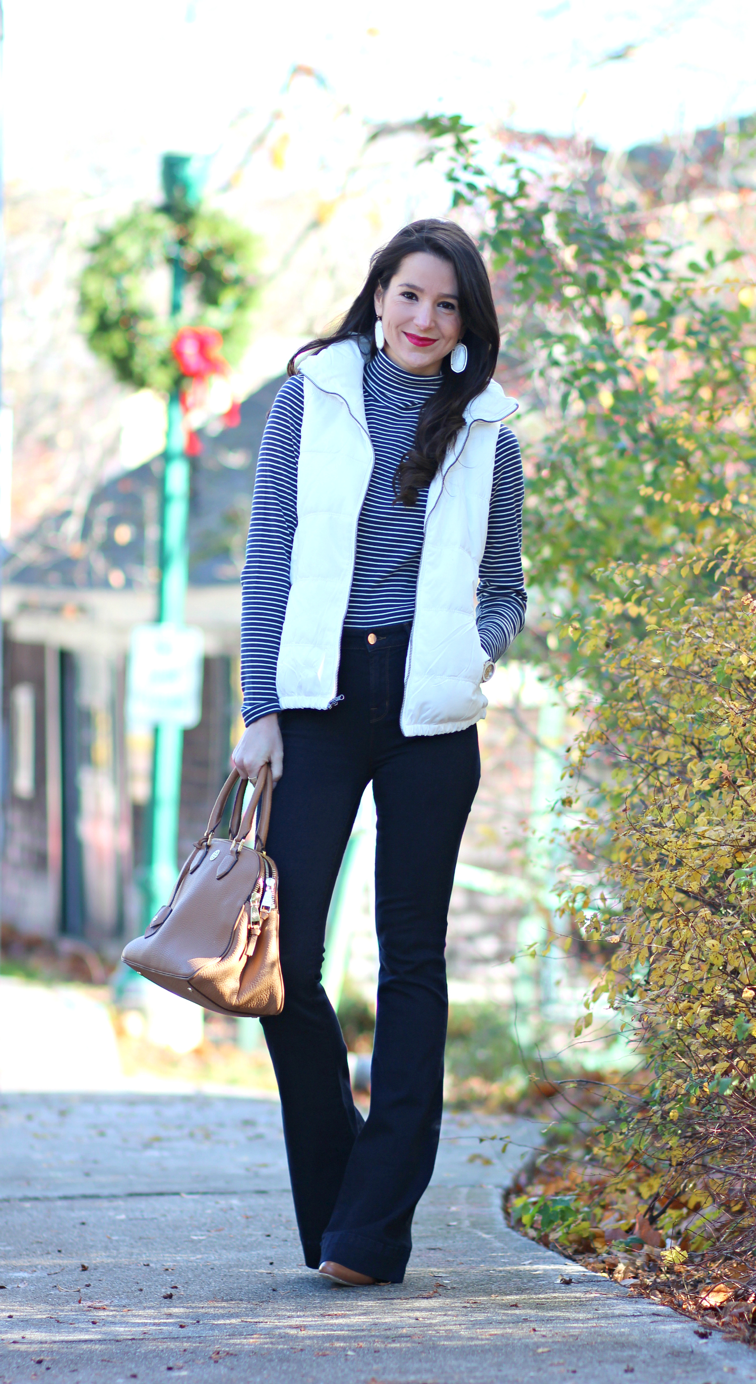 Cute and preppy fall outfit idea with J Brand dark wash flare jeans, Old Navy white puffer vest, and LL Bean striped turtleneck