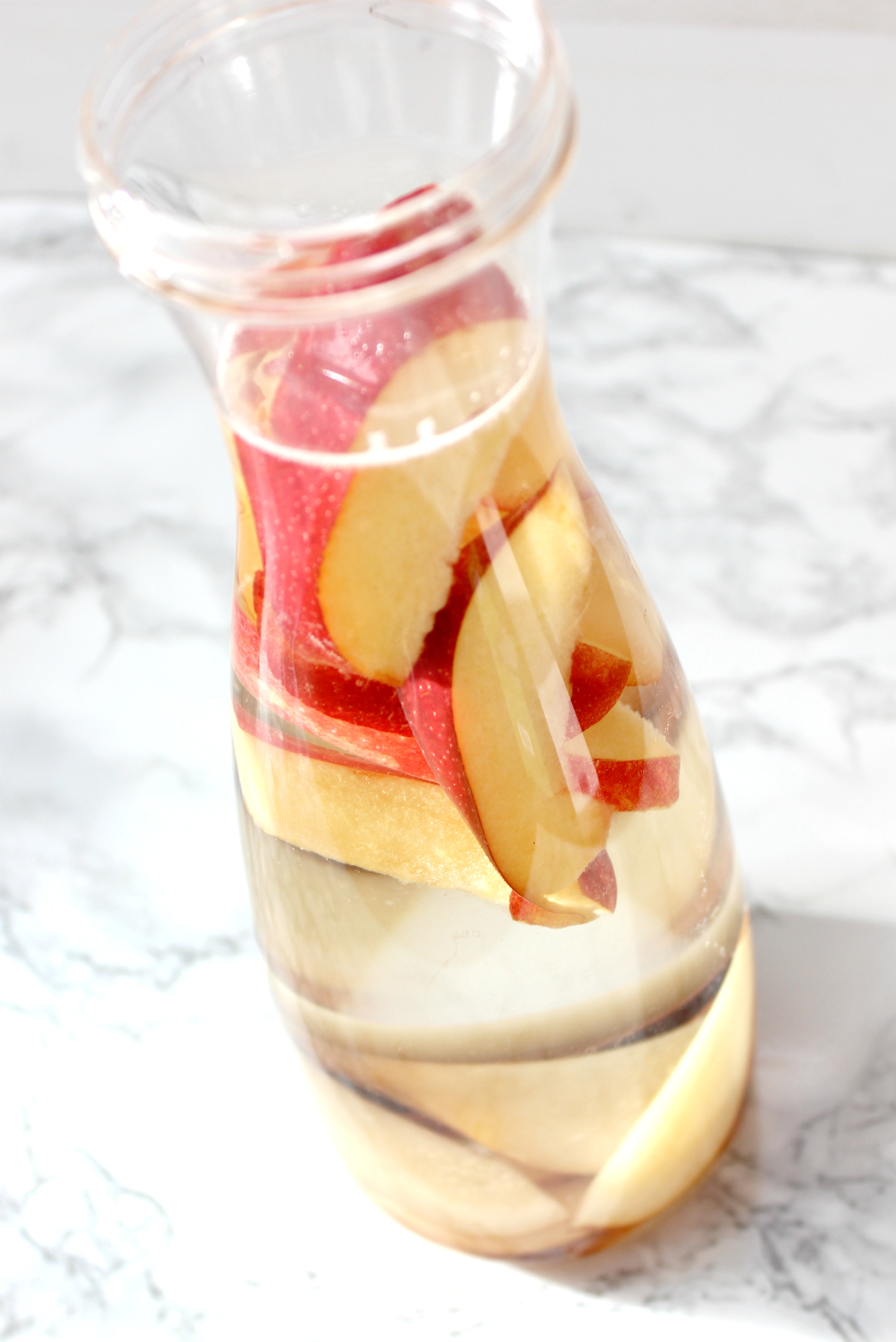 This cinnamon apple pear fall detox water is a must-try this holiday season for warding off stomach aches and holiday sugar highs!
