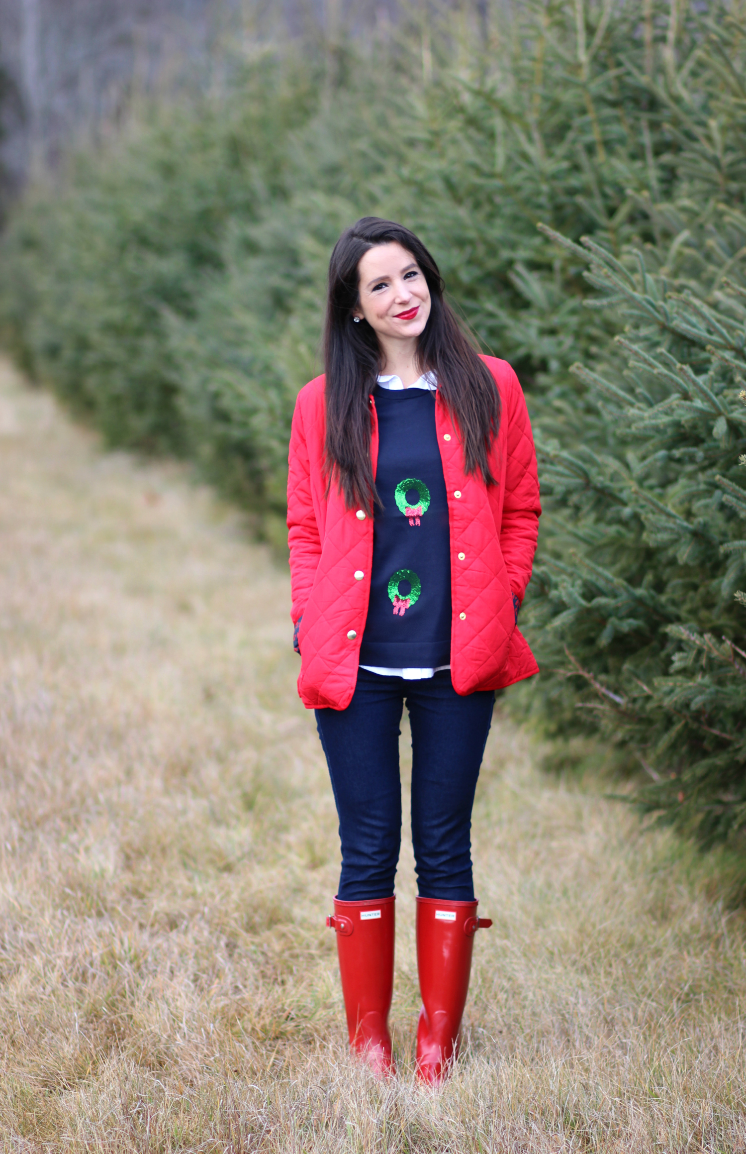 Cutting down our Christmas tree in the perfect affordable quilted red jacket from Crown & Ivory