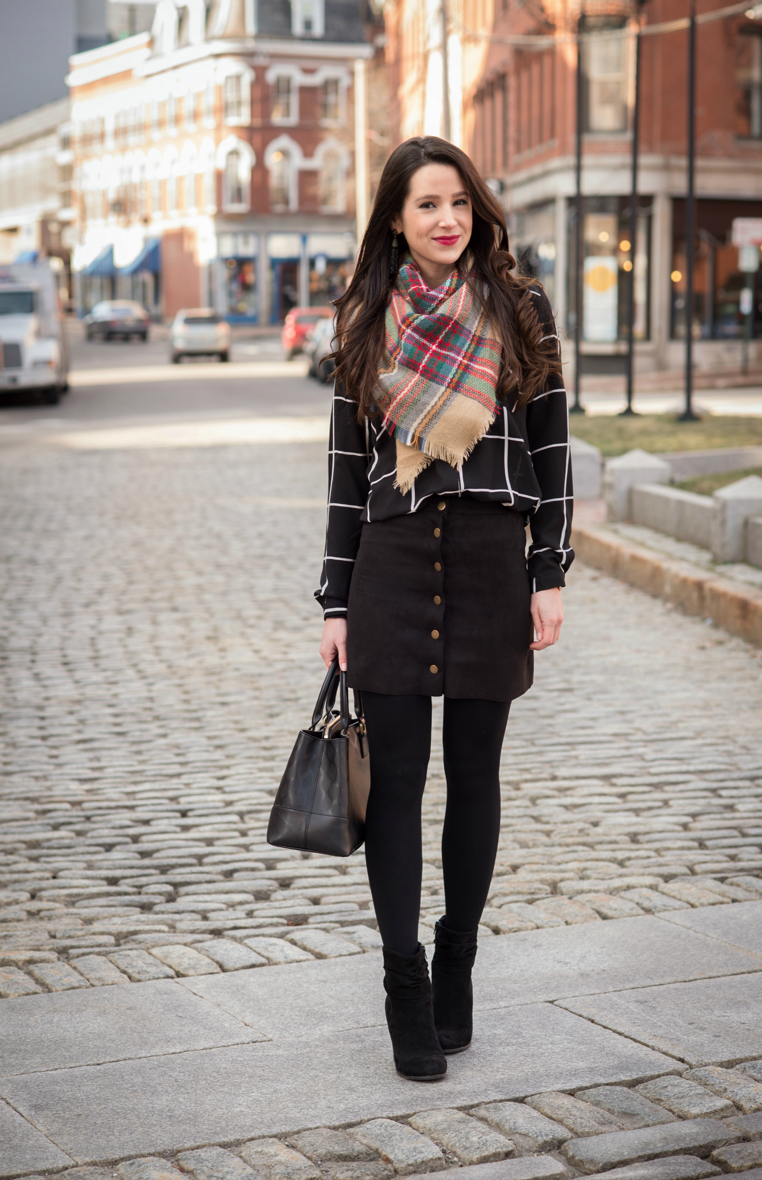 Chic all black winter outfit with a pop of color in the scarf