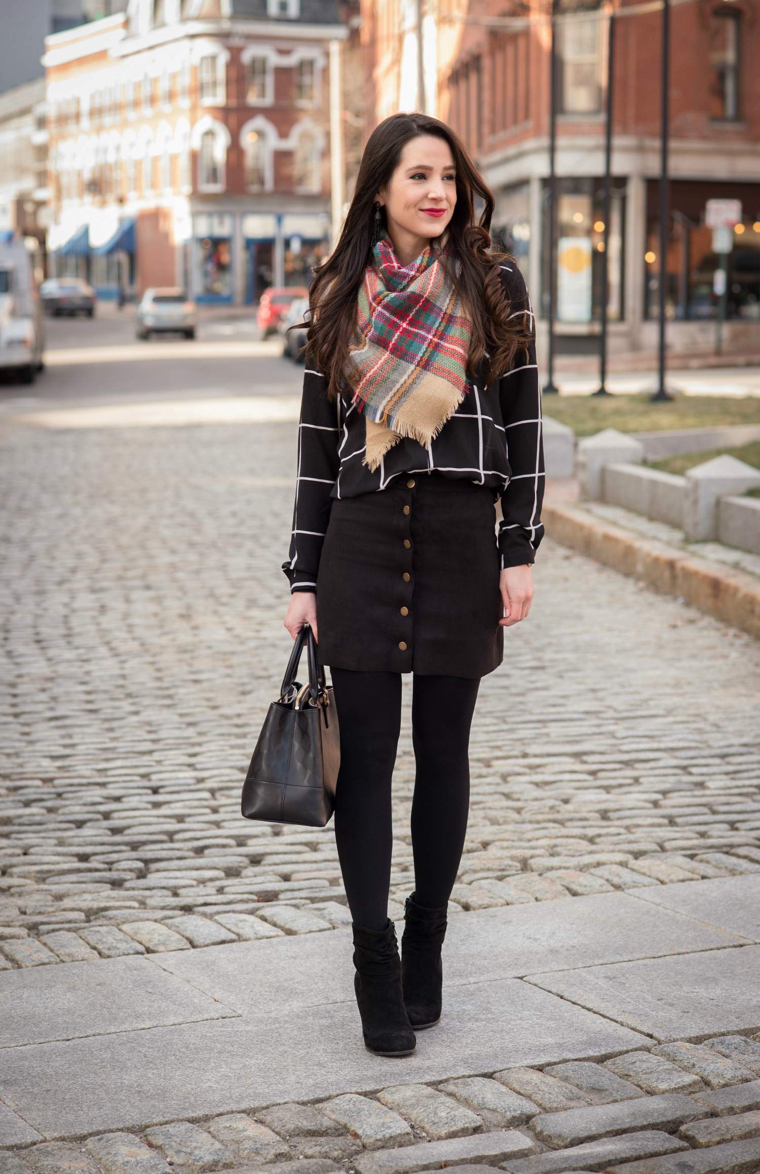 Chic all black winter outfit with a pop of color in the scarf