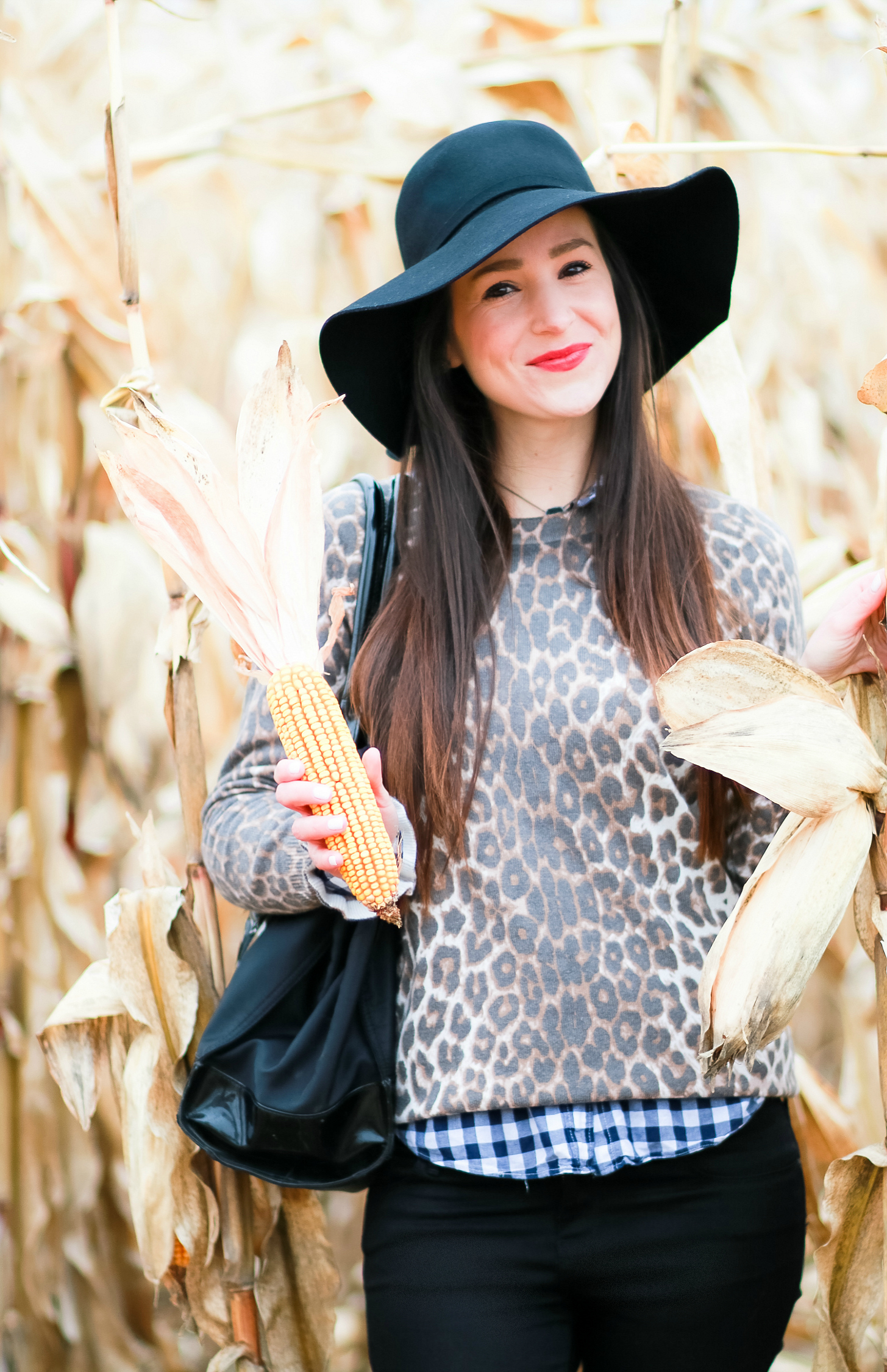 Black floppy hat with leopard crewneck sweater, J.Crew Factory blue gingham button down, black jeans, Nine West tall black boots, and a Tory Burch Ella tote | Comfy and casual fall outfit idea | How to wear a floppy hat in the fall by fashion blogger Stephanie Ziajka from Diary of a Debutante