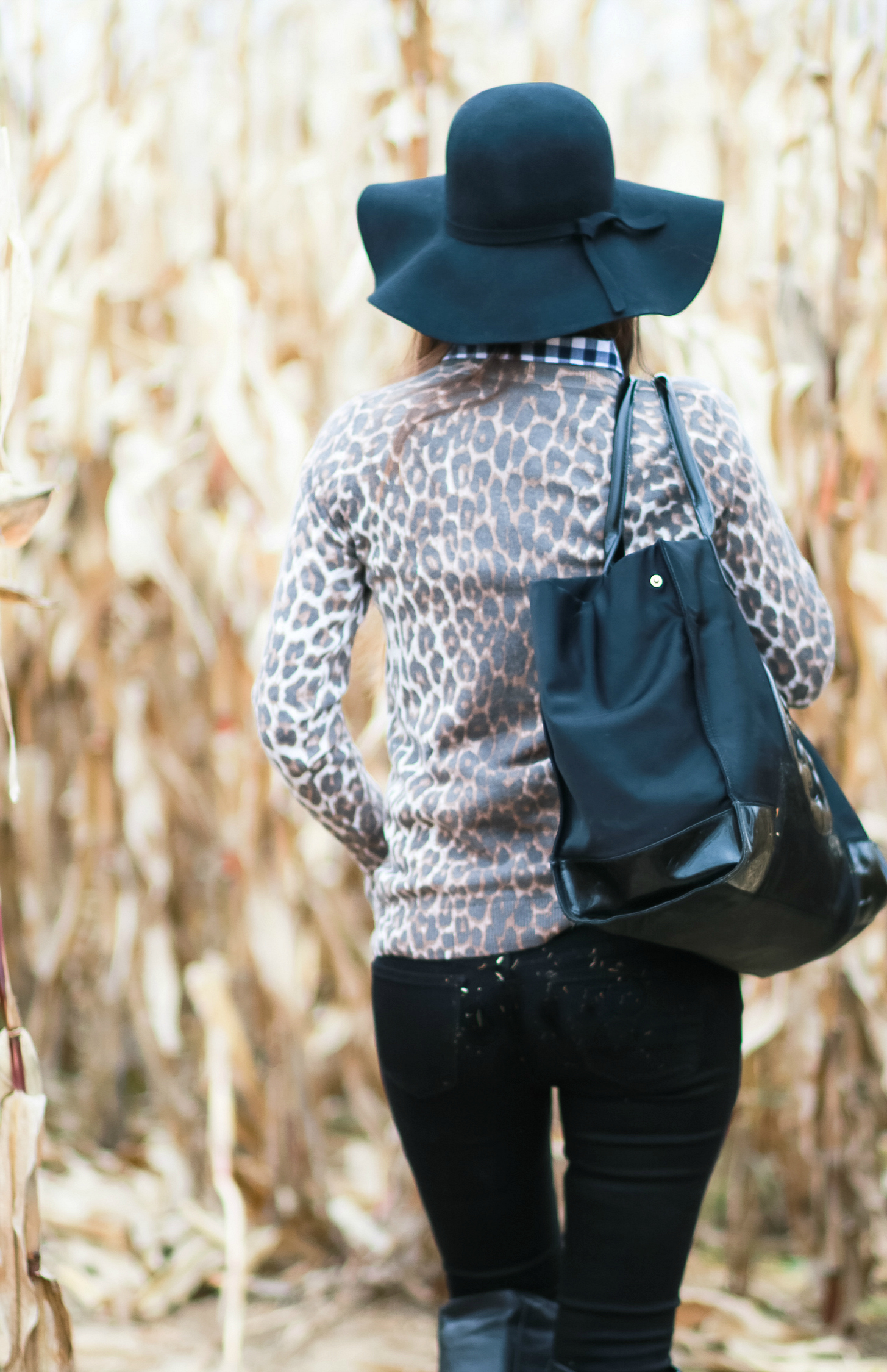 Black floppy hat with leopard crewneck sweater, J.Crew Factory blue gingham button down, black jeans, Nine West tall black boots, and a Tory Burch Ella tote | Comfy and casual fall outfit idea | Floppy hat outfit idea | How to wear a floppy hat in the fall by fashion blogger Stephanie Ziajka from Diary of a Debutante