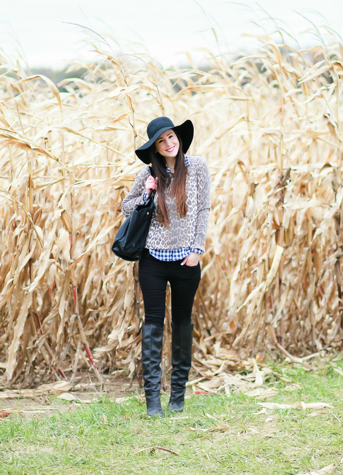Black floppy hat with leopard crewneck sweater, J.Crew Factory blue gingham button down, black jeans, Nine West tall black boots, and a Tory Burch Ella tote | Comfy and casual fall outfit idea | Floppy hat outfit idea | How to wear a floppy hat in the fall by fashion blogger Stephanie Ziajka from Diary of a Debutante