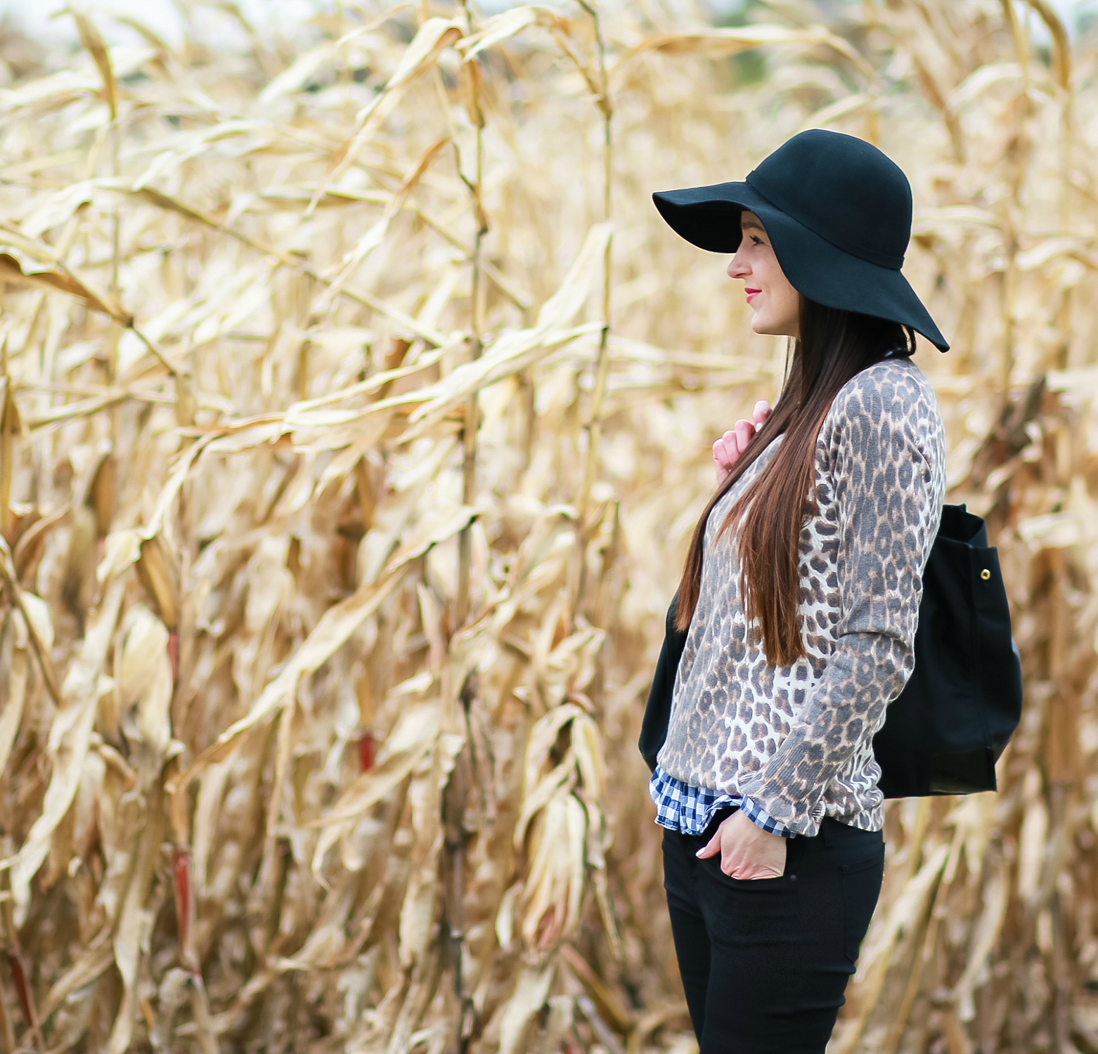 Black floppy hat with leopard crewneck sweater, J.Crew Factory blue gingham button down, black jeans, Nine West tall black boots, and a Tory Burch Ella tote | Comfy and casual fall outfit idea | How to wear a floppy hat in the fall by fashion blogger Stephanie Ziajka from Diary of a Debutante