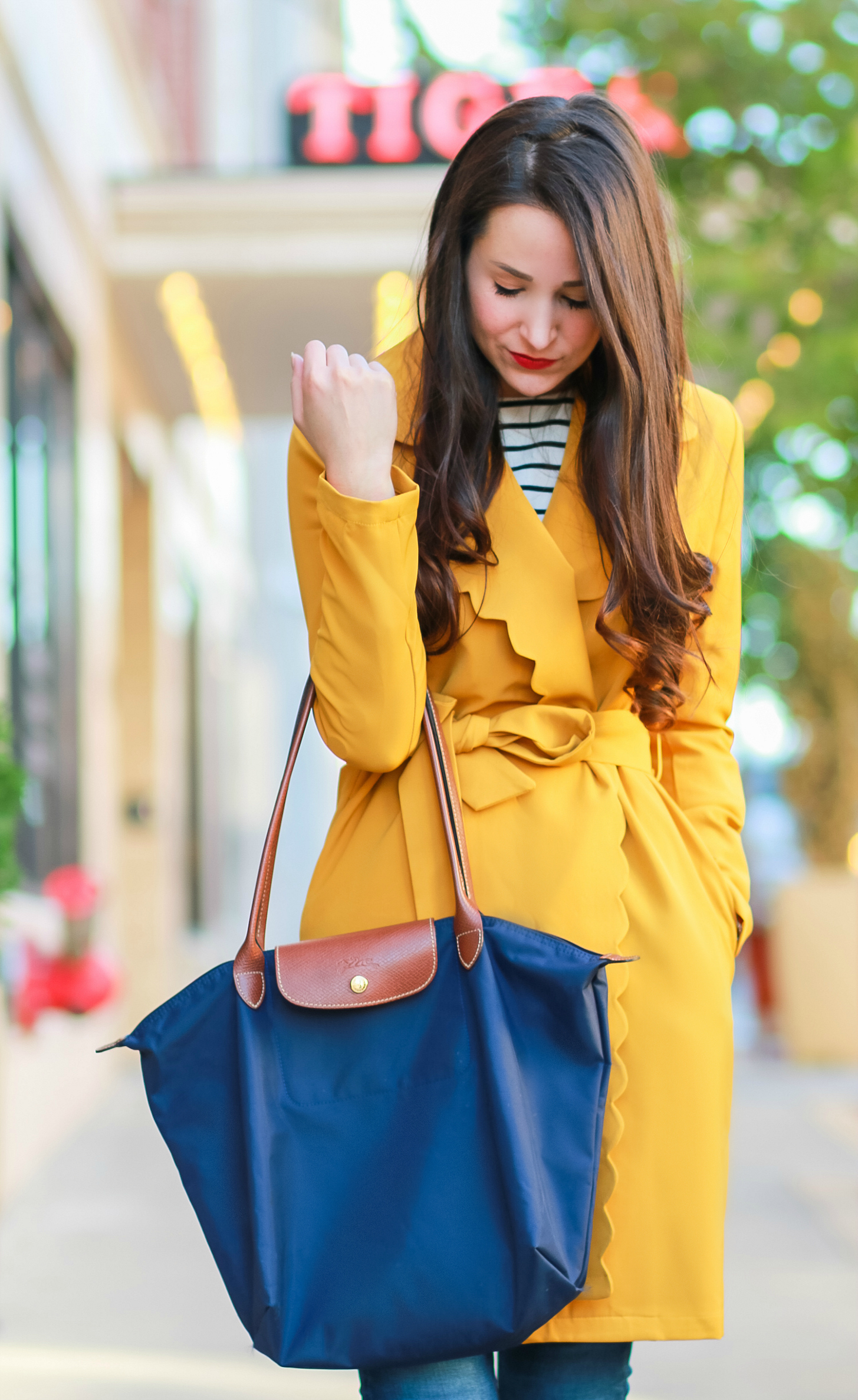 Marigold scalloped coat with AG skinny jeans, English Factory striped top, Nine West brown tall boots, and large navy Longchamp tote | Color Crush: Marigold Scalloped Coat by fashion blogger Stephanie Ziajka from Diary of a Debutante