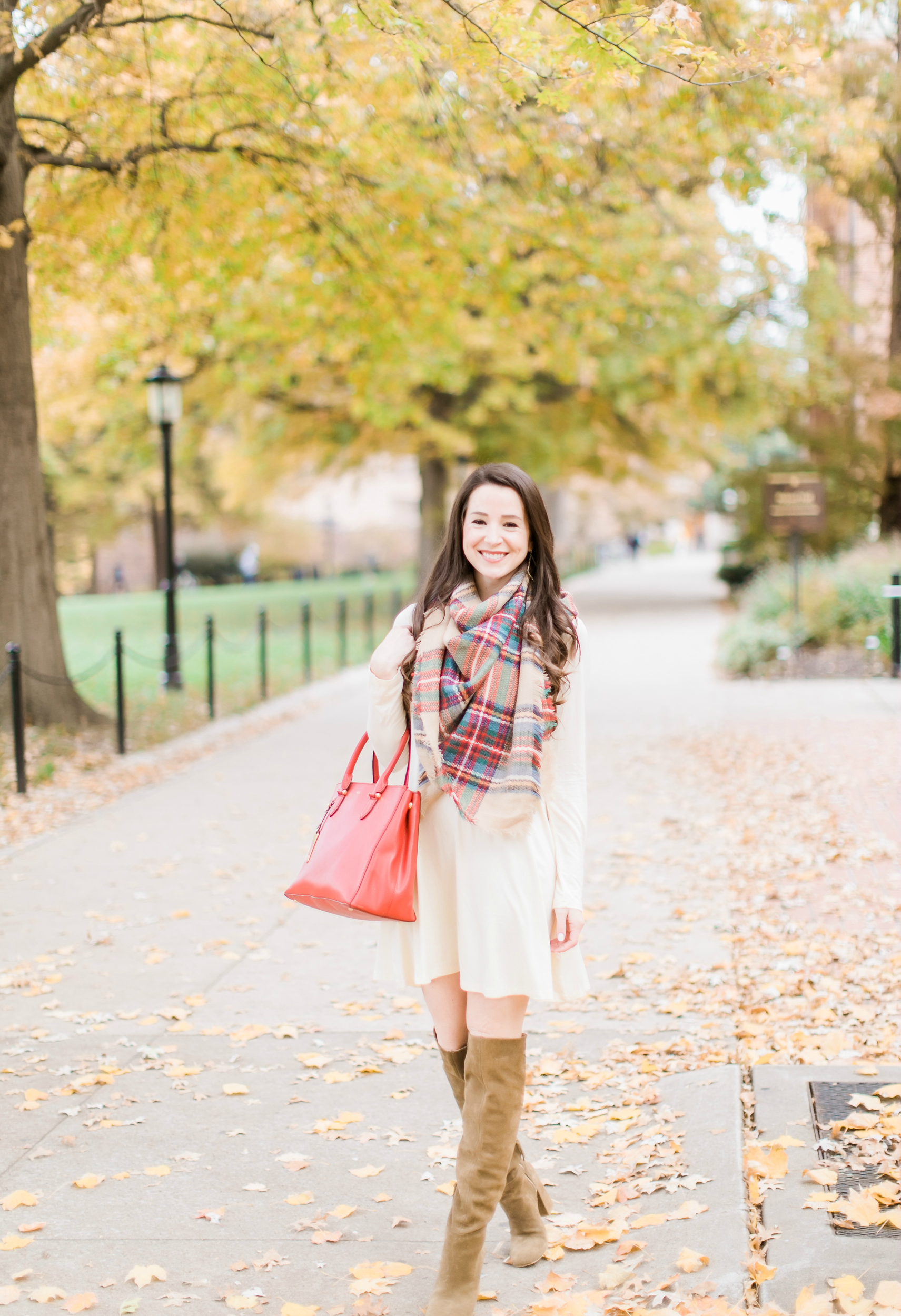 Beige cotton swing dress with tartan blanket scarf, Free People cognac OTK boots, red Ralph Lauren handbag, and Kendra Scott Sophee earrings | Casual holiday outfit idea | 10 tips for looking your best on camera | Tips for Looking Your Best in Holiday Photos from fashion blogger Stephanie Ziajka of Diary of a Debutante