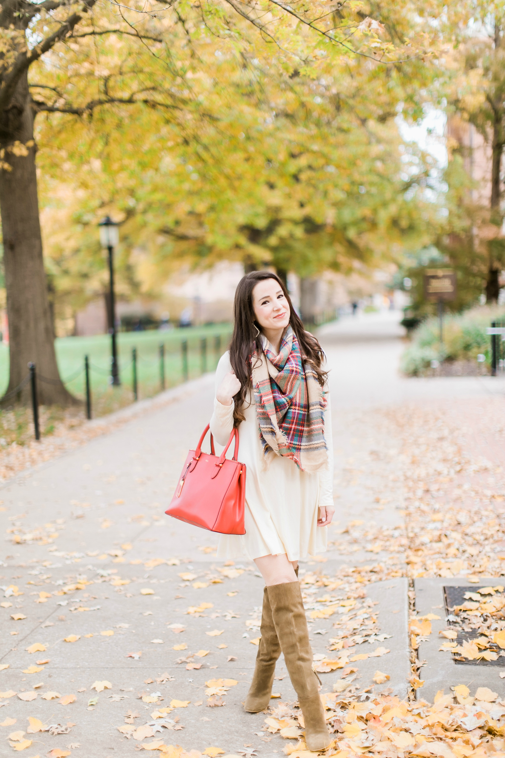 Beige cotton swing dress with tartan blanket scarf, Free People cognac OTK boots, red Ralph Lauren handbag, and Kendra Scott Sophee earrings | Casual holiday outfit idea | 10 tips for looking your best on camera | Tips for Looking Your Best in Holiday Photos from fashion blogger Stephanie Ziajka of Diary of a Debutante