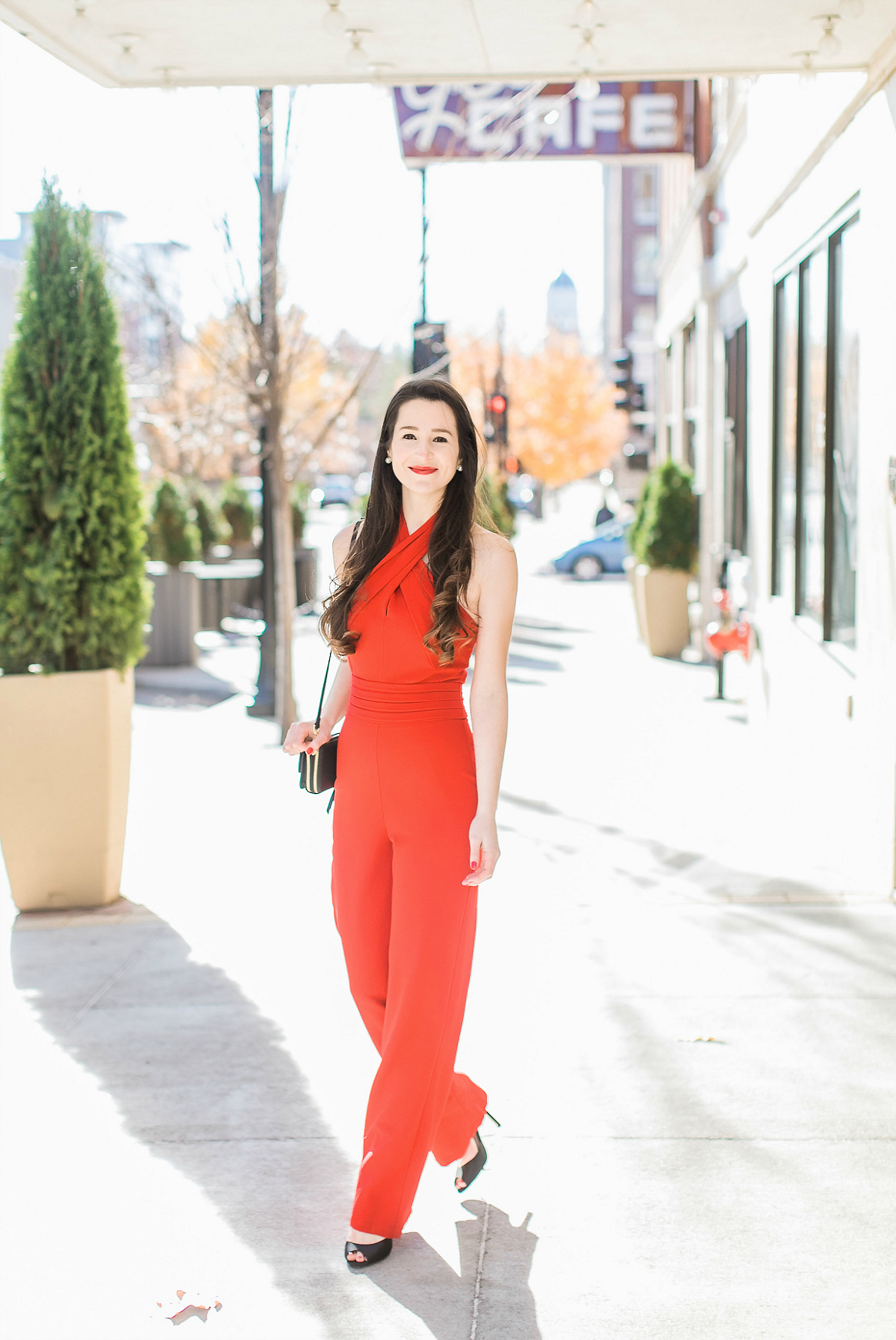 Adelyn Rae red wide leg jumpsuit styled with a black Vera Bradley RFID All-in-One Crossbody bag and Nina Shoes peep toe sandals by southern fashion blogger Stephanie Ziajka from Diary of a Debutante