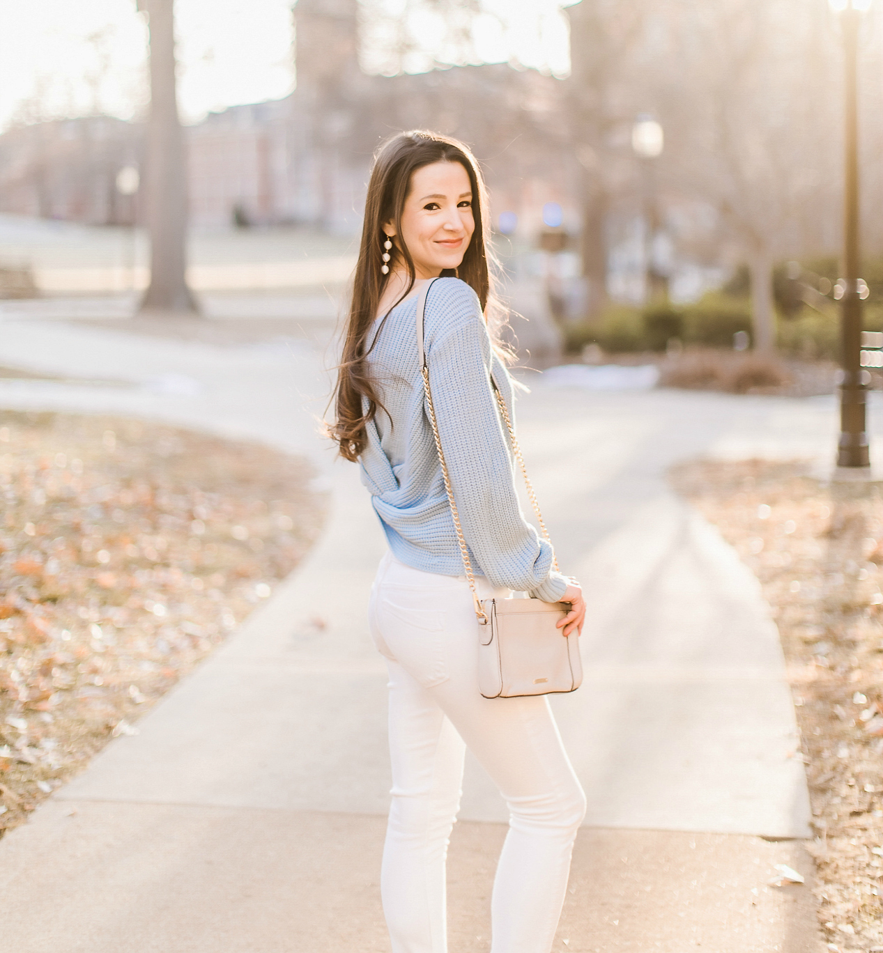 Affordable light blue twist front sweater styled with Express white skinny jeans, Nine West light blue suede heels, Rebecca Minkoff Avery crossbody, white Michele Cape watch, and Sugarfix by Baublebar triad ball drop earrings, How to beat a winter style rut by southern fashion blogger Stephanie Ziajka from Diary of a Debutante, Fashion Photography by Catherine Rhodes Photography