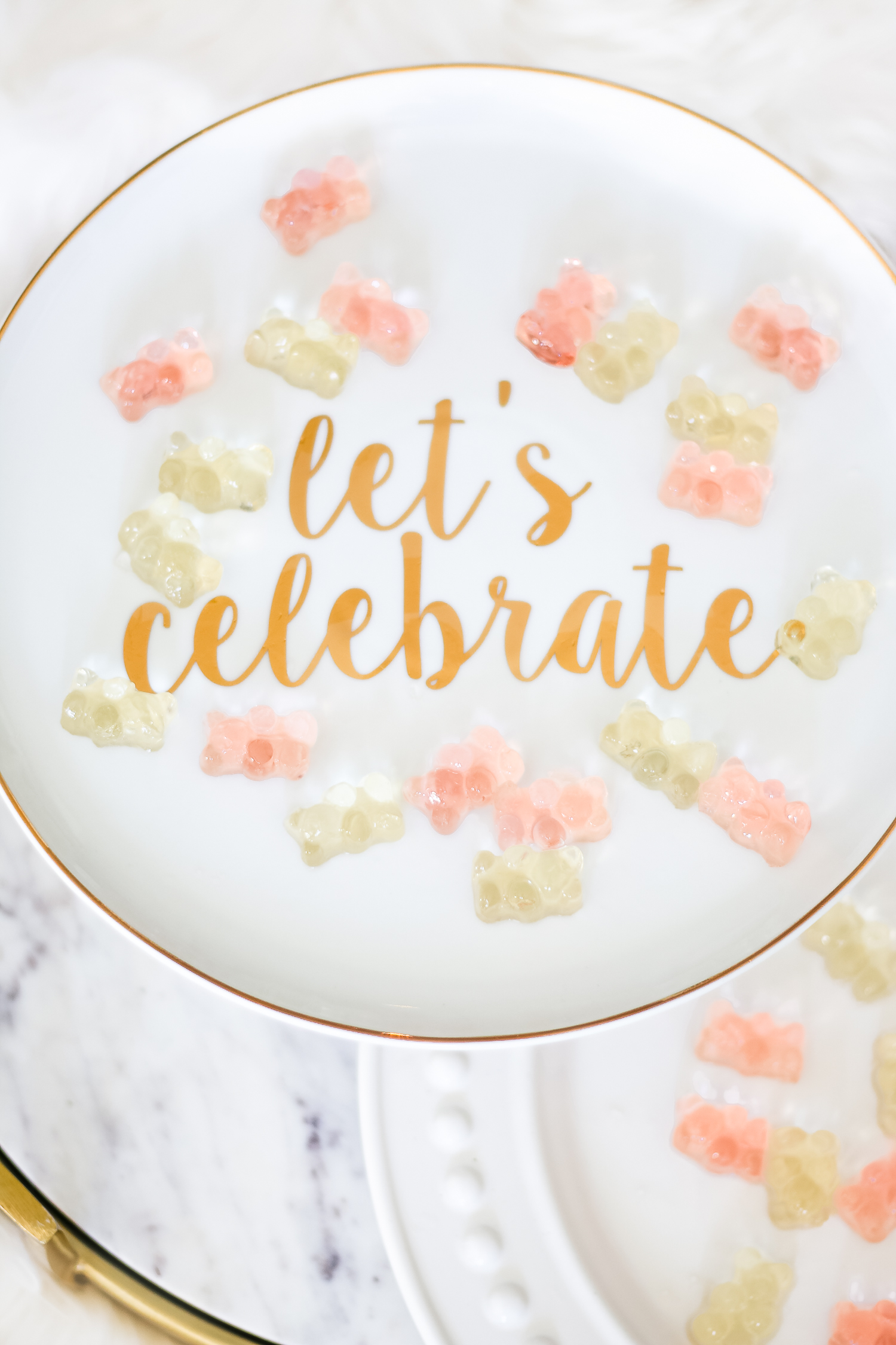 How to make champagne gummy bears by southern lifestyle blogger Stephanie Ziajka from Diary of a Debutante, easy champagne soaked gummy bears recipe using Sugarfina Champagne Bears Gummy Candy, ceramic Let's Celebrate cake stand