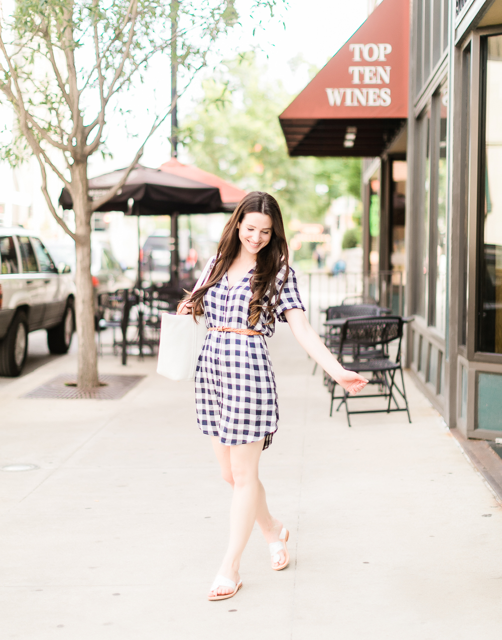 How to wear a plaid shirtdress in the summer by southern fashion blogger Stephanie Ziajka from Diary of a Debutante, how to wear plaid shirtdress, plaid shirt dress outfit, style plaid, BB Dakota Cicely Shirtdress styled with white Jack Rogers sandals, a white Vera Bradley Mallory tote, skinny braided leather belt, and large pearl stud earrings