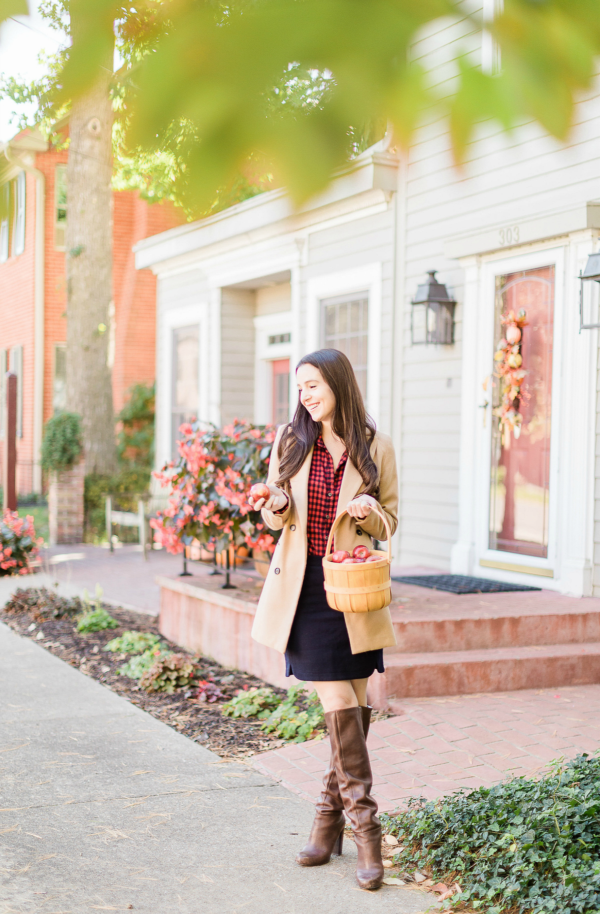 4 Preppy Fall Essentials to Add to Your Cold Weather Wardrobe by affordable style blogger Stephanie Ziajka from Diary of a Debutante, cute preppy fall outfits, LL Bean red gingham button down styled with a Shein double breasted camel coat, J.Crew Factory navy wool skirt, and Nine West block heel tall boots