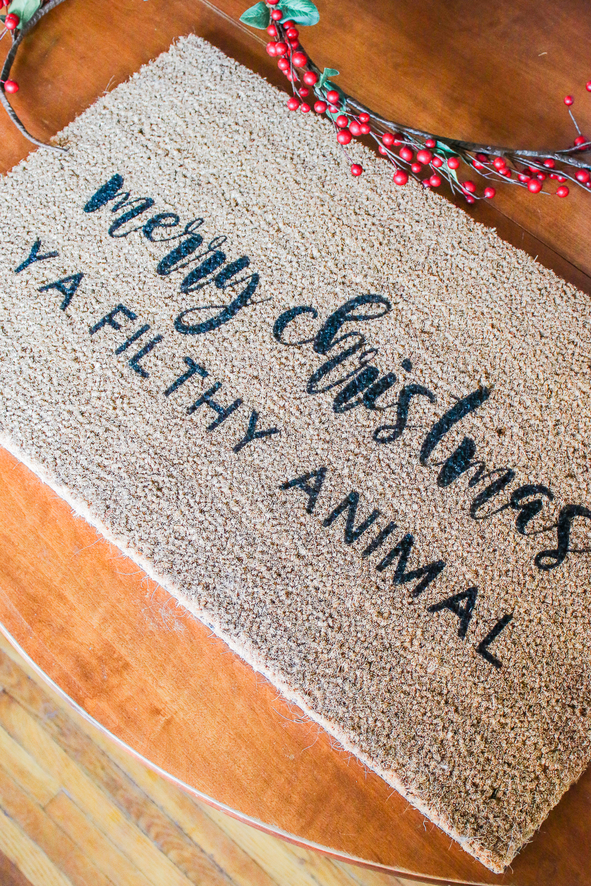 "Merry Christmas Ya Filthy Animal" DIY Painted Doormat by southern lifestyle blogger Stephanie Ziajka from Diary of a Debutante, DIY doormat stencil with Cricut Explore Air 2, Cricut doormat tutorial, DIY outdoor mat, paint your own doormat tutorial, paint doormat