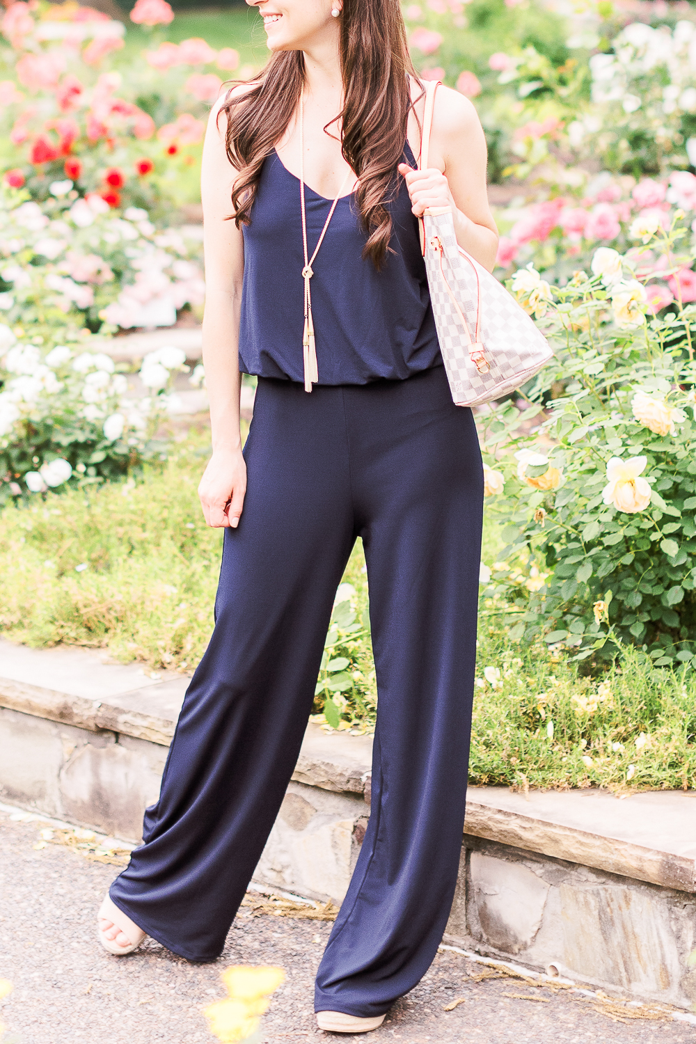 Summer Style Guide: How to Wear a Jumpsuit Casually by popular affordable fashion blogger Stephanie Ziajka from Diary of a Debutante, how to style navy jumpsuit, best shoes to wear with a jumpsuit, navy URBAN K Women's Racerback Jumpsuit, Louis Vuitton Neverfull Dupe Bag, Kendra Scott Phara Necklace