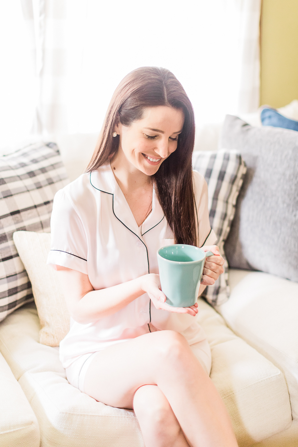 Morning Self-Care Routine + Sonic-Fushion Flossing Toothbrush Review by popular southern lifestyle blogger Stephanie Ziajka from Diary of a Debutante, drinking coffee on the couch, pink silk pajama set