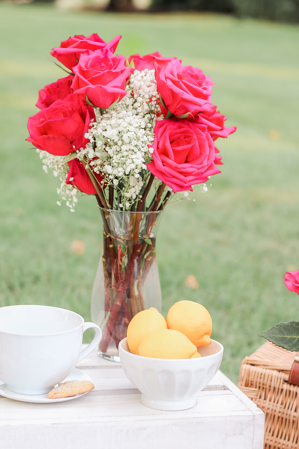 Pink roses and baby's breath at a tea party picnic