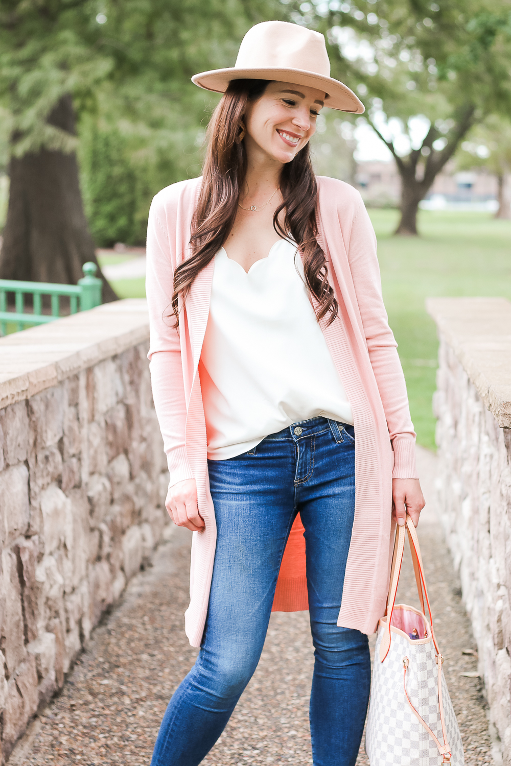 Amazon light pink cardigan styled with J.Crew Factory scalloped cami top, AG the Legging super skinny jeans, Amazon Louis Vuitton Neverfull dupe bag, and Amazon Lanzom wide brim fedora hat by popular affordable style blogger Stephanie Ziajka on Diary of a Debutante