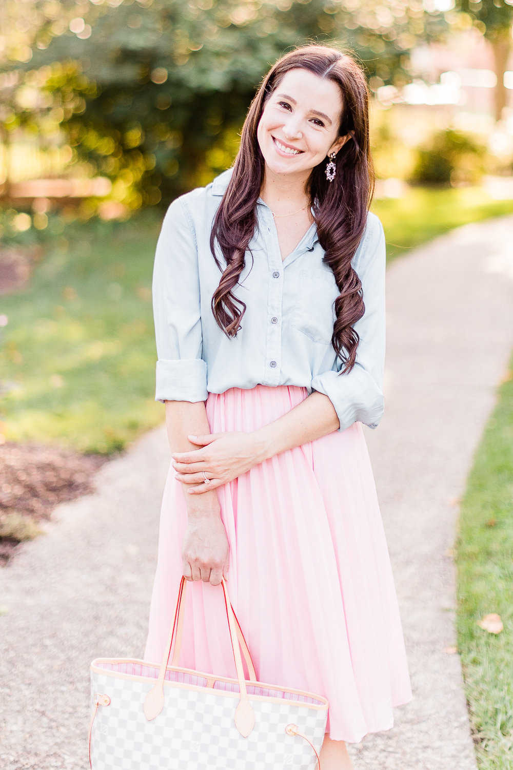 Day to Night: How to Wear a Pink Midi Skirt in the Fall by popular affordable fashion blogger Stephanie Ziajka on Diary of a Debutante, Amazon pink pleated midi skirt styled with SO chambray button down shirt, Amazon nude block heel sandals, and a Louis Vuitton Neverfull dupe bag