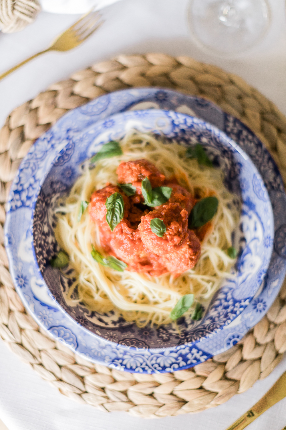 Spaghetti and Pure Farmland Plant-Based Meatballs Recipe by affordable entertaining blogger Stephanie Ziajka from Diary of a Debutante, blue and white tablescape idea, blue and white Italian tablescape, Spode Blue Italian Dinner Plates and Pasta Bowls, blue delft tablescape idea