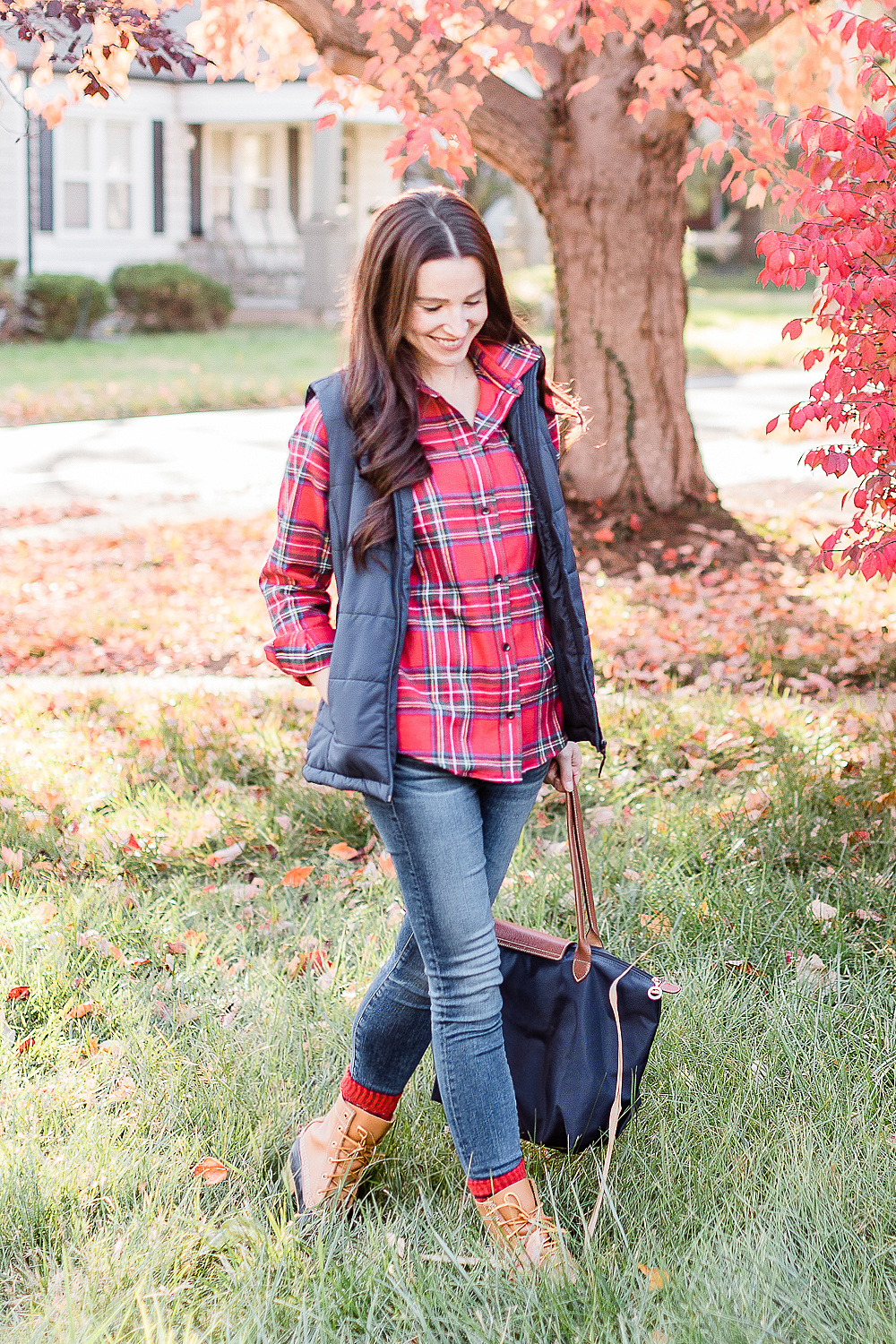 10 Best LL Bean Products for Winter by popular affordable fashion blogger Stephanie Ziajka on Diary of a Debutante, LL Bean Royal Stewart Tartan Relaxed Flannel styled with Classic Bean Boots, Navy Amazon Essentials Puffer Vest, AG Ankle Skinny Jeans, and a Navy Longchamp Le Pliage Tote 