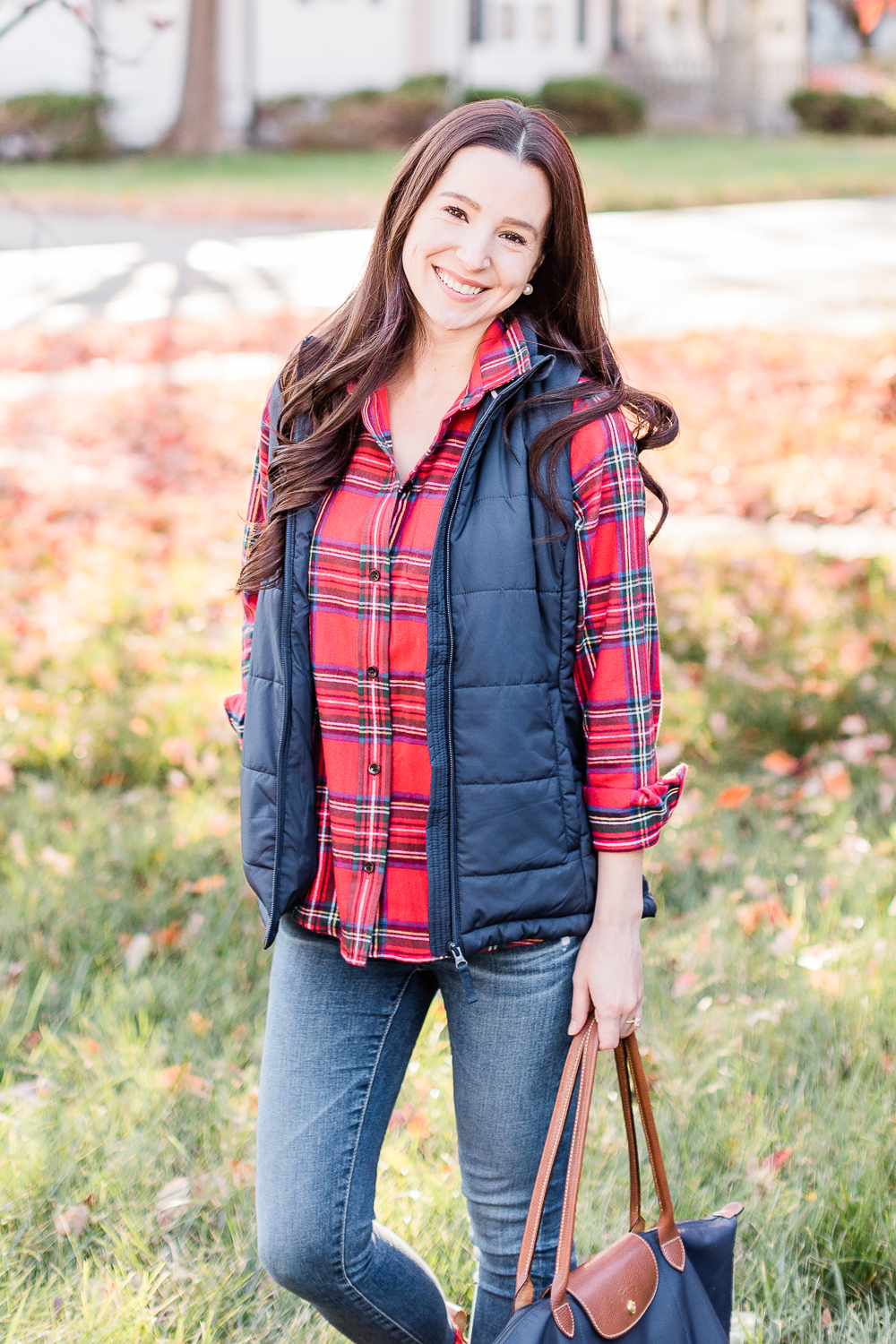10 Best LL Bean Products for Winter by popular affordable fashion blogger Stephanie Ziajka on Diary of a Debutante, LL Bean Royal Stewart Tartan Relaxed Flannel styled with Classic Bean Boots, Navy Amazon Essentials Puffer Vest, AG Ankle Skinny Jeans, and a Navy Longchamp Le Pliage Tote 