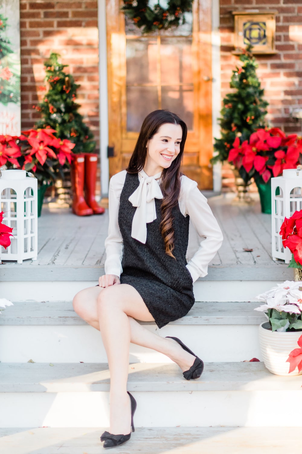 Affordable fashion blogger Stephanie Ziajka styles one of her favorite classy christmas party dresses with a white tie-neck chiffon blouse and black pointed toe bow heels on Diary of a Debutante