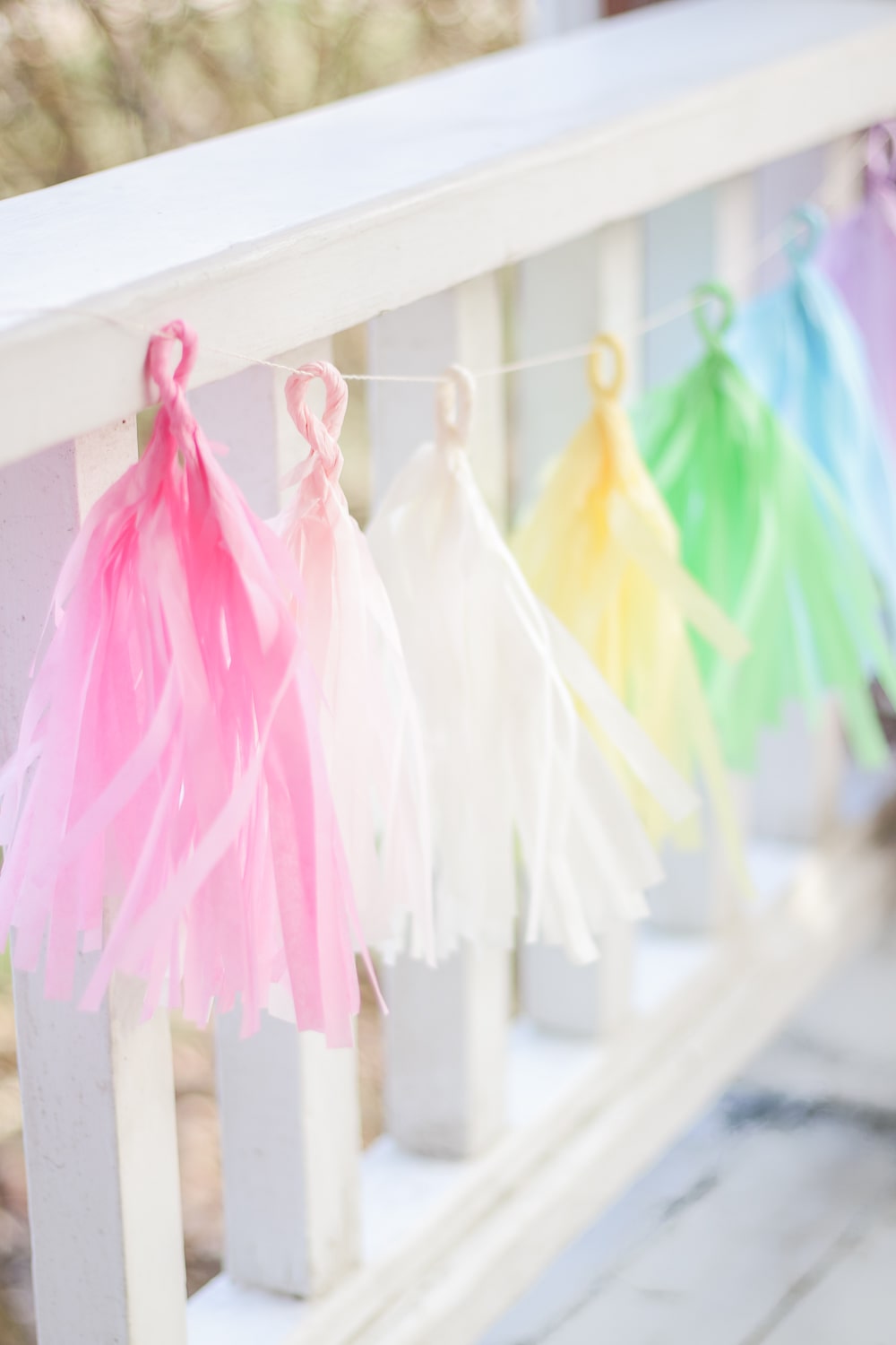 DIY blogger Stephanie Ziajka of Diary of a Debutante shows how she made her own pastel tissue tassel garland for spring