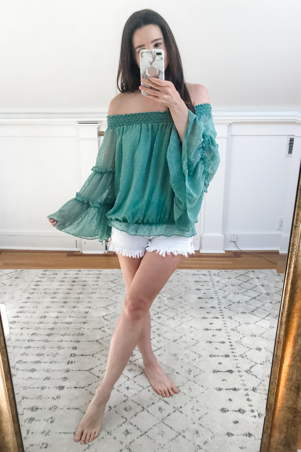 Affordable fashion blogger Stephanie Ziajka tries on a green Amazon off shoulder chiffon blouse with tiered bell sleeves on Diary of a Debutante