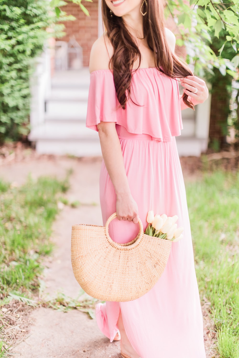 Affordable fashion blogger Stephanie Ziajka styles an off shoulder pink maxi dress with a round handle straw handbag on Diary of a Debutante