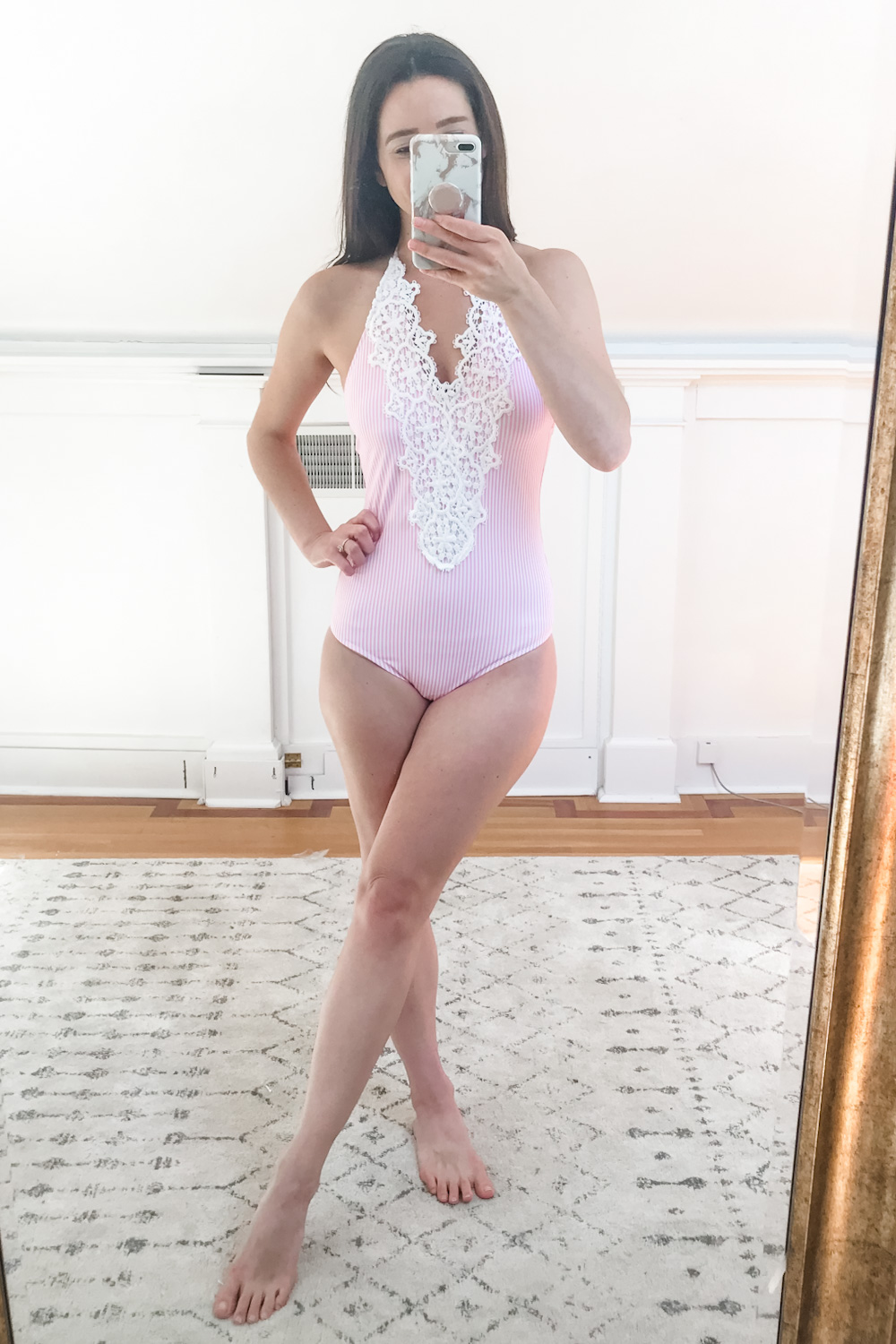 Affordable fashion blogger Stephanie Ziajka tries on a pink and white striped Amazon lace halter top one piece swimsuit on Diary of a Debutante
