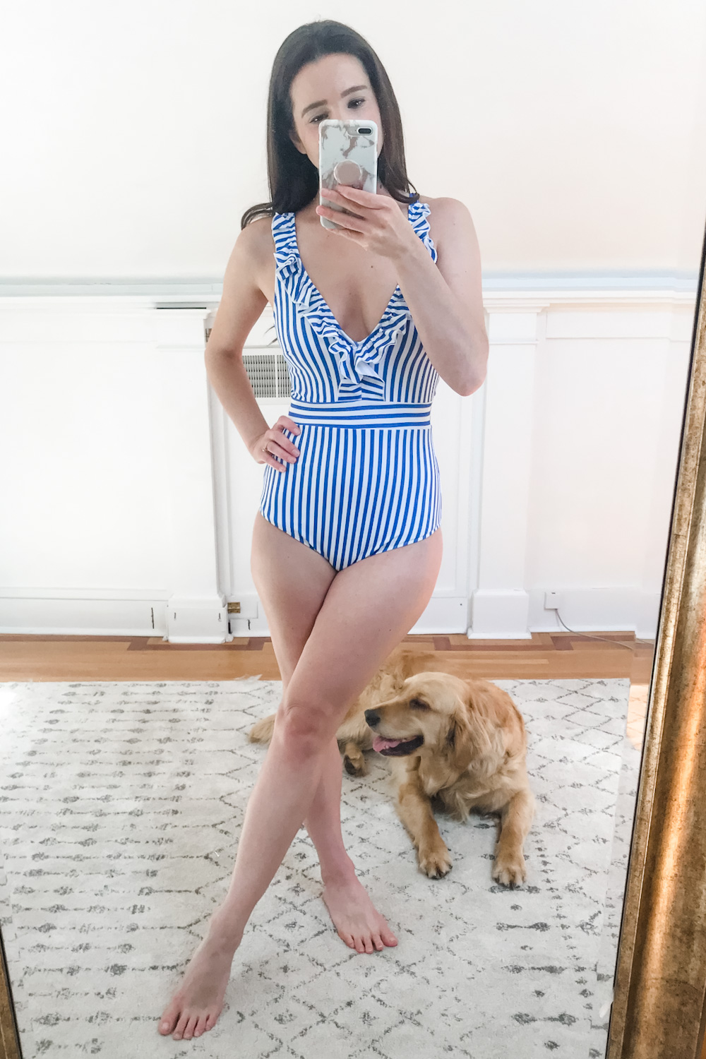 Affordable fashion blogger Stephanie Ziajka tries on a blue and white striped CUPSHE ruffle one piece swimsuit on Diary of a Debutante