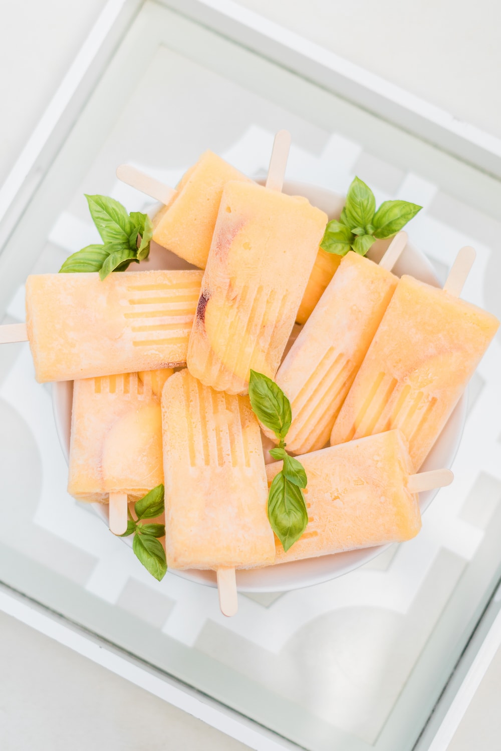 Boozy bellini popsicles recipe by southern lifestyle blogger Stephanie Ziajka on Diary of a Debutante