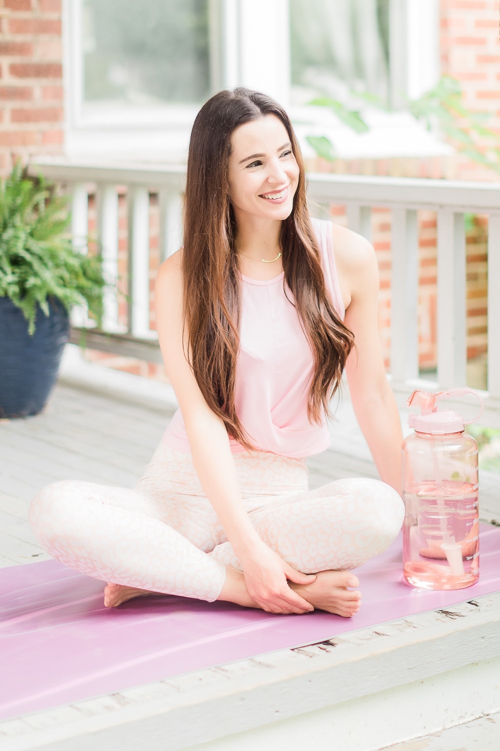 Cute yoga outfit styled with a pink tie front crop top and leopard leggings by affordable fashion blogger Stephanie Ziajka on Diary of a Debutante