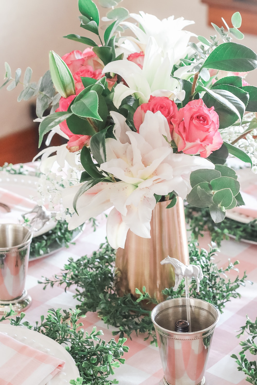 Derby Day centerpiece made with pink roses, white rose lilies, and greenery and designed by entertaining blogger Stephanie Ziajka on Diary of a Debutante