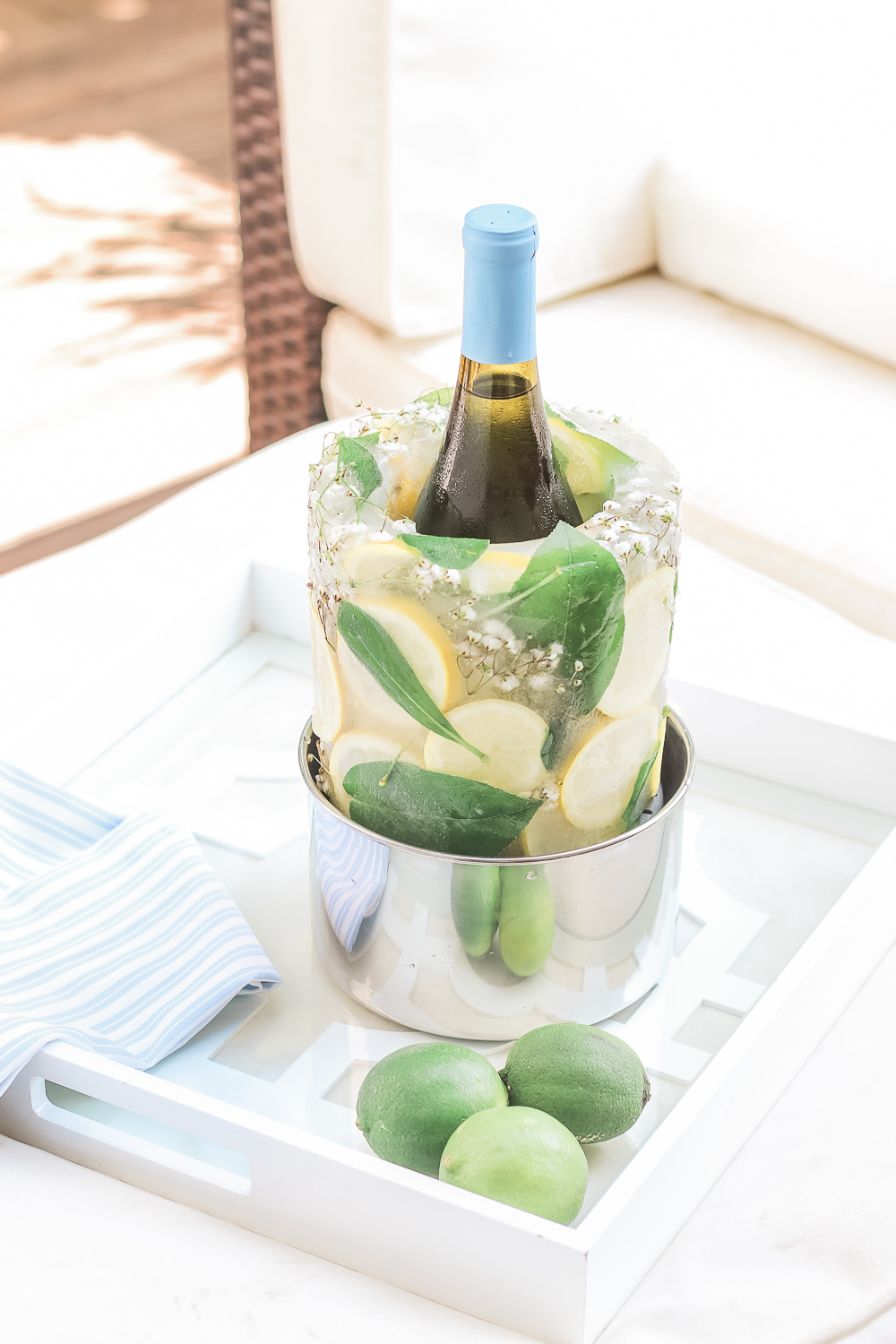 Entertaining blogger Stephanie Ziajka shows how to make your own DIY wine chiller for summer out of lemon slices, greenery, and baby's breath on Diary of a Debutante
