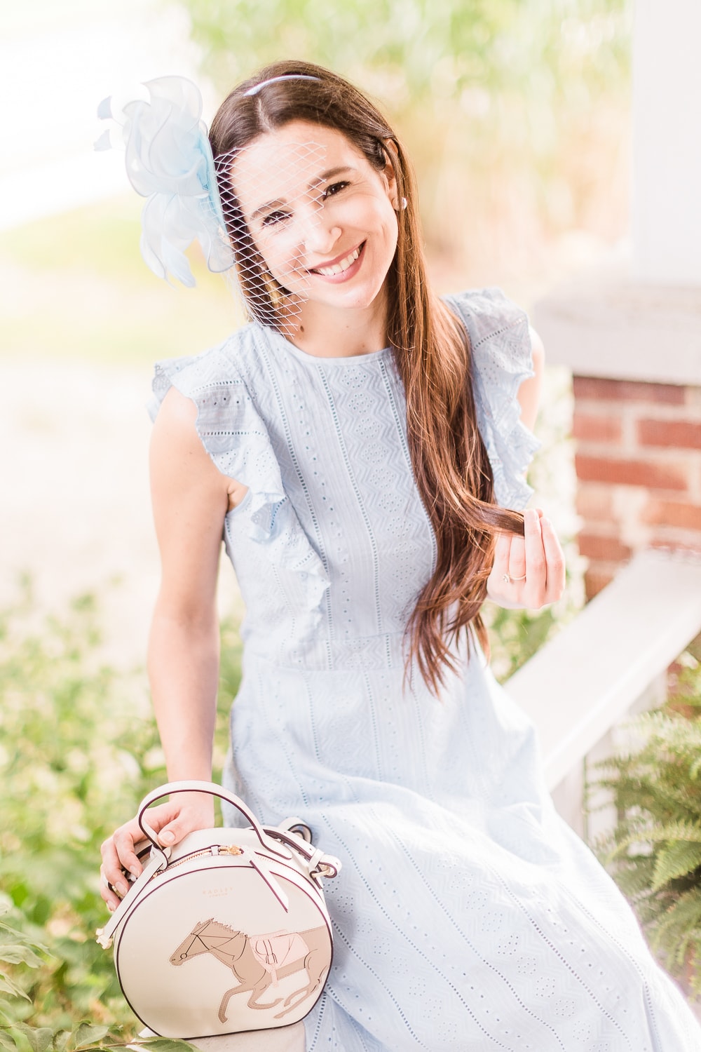 Light blue Kentucky derby outfit accessorized with a light blue fascinator and Radley London Royal Ascot crossbody bag by affordable fashion blogger Stephanie Ziajka on Diary of a Debutante