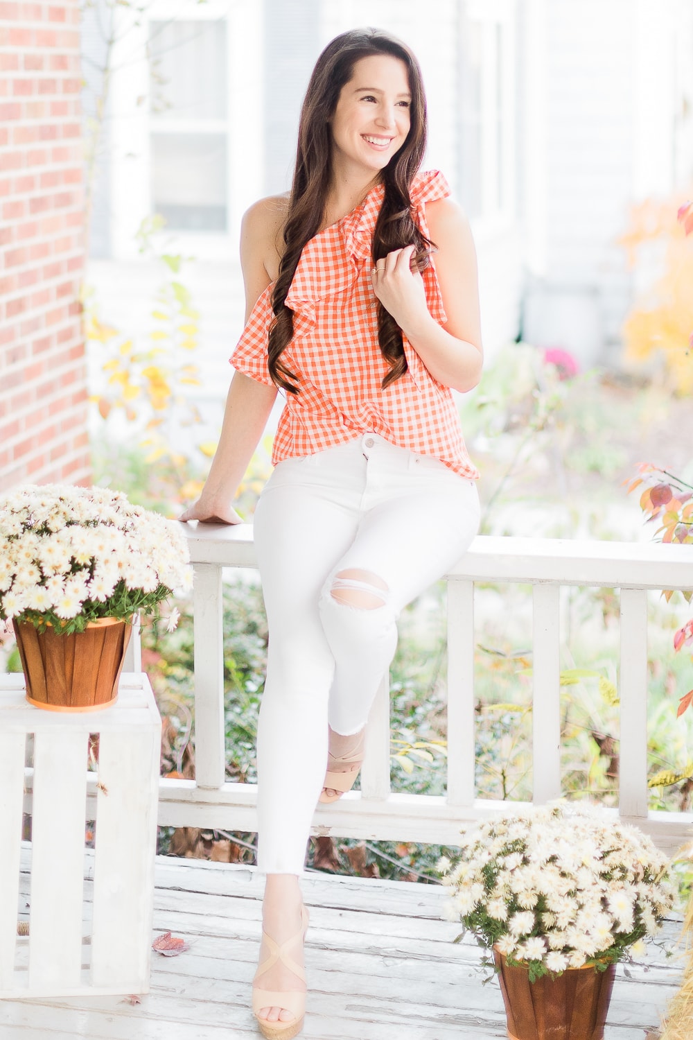 Affordable fashion blogger Stephanie Ziajka styles an orange gingham top with white distressed skinny jeans and tan wedges on Diary of a Debutante