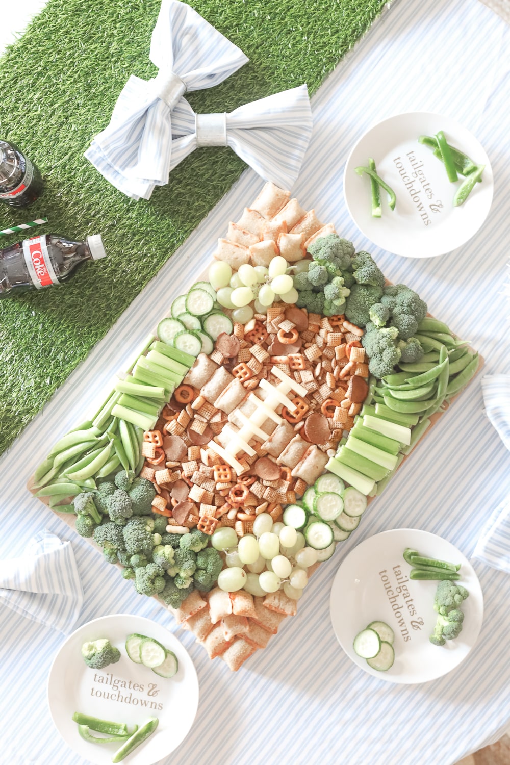 Blogger Stephanie Ziajka shows how to create a game day grazing board with green grapes, green veggies, Chex Mix, and Totino's Pizza Rolls on Diary of a Debutante