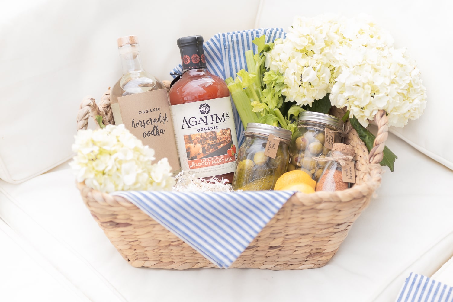 Bloody mary basket filled with horseradish vodka, Agalima Organic bloody mary mix and a variety of bloody mary garnishes by blogger Stephanie Ziajka on Diary of a Debutante
