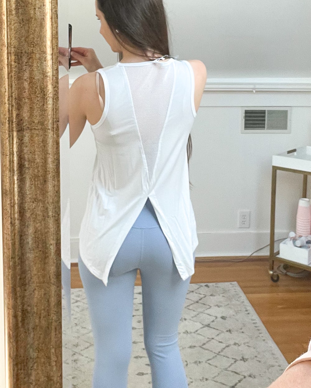Affordable fashion blogger Stephanie Ziajka shows off the back detail of her white Amazon open back workout tank on Diary of a Debutante