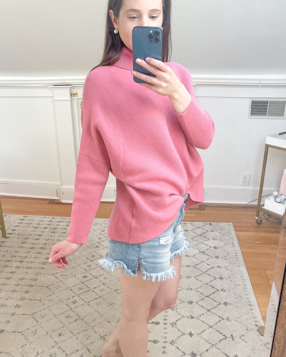 Affordable fashion blogger Stephanie Ziajka shares a close-up of her rubber pink Amazon long batwing sleeve asymmetrical hem pullover sweater on Diary of a Debutante