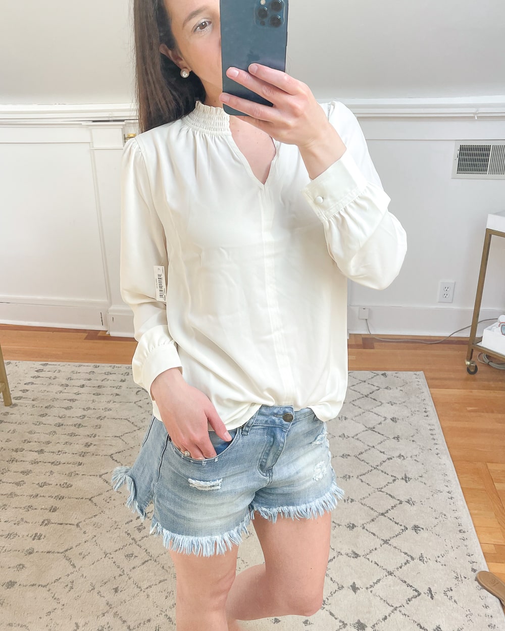 Affordable fashion blogger Stephanie Ziajka shares a detail shot of her Vanilla Ice Lark & Ro Women's Crepe de Chine Long Sleeve Split Mock Neck Top with Smocked Detail as part of a spring try-on haul on Diary of a Debutante