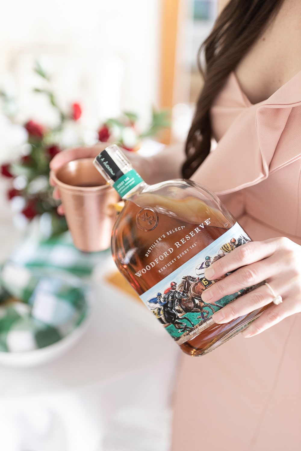 Blogger Stephanie Ziajka pours Woodford Reserve Special Edition Kentucky Derby bourbon whiskey into a copper julep cup on Diary of a Debutante