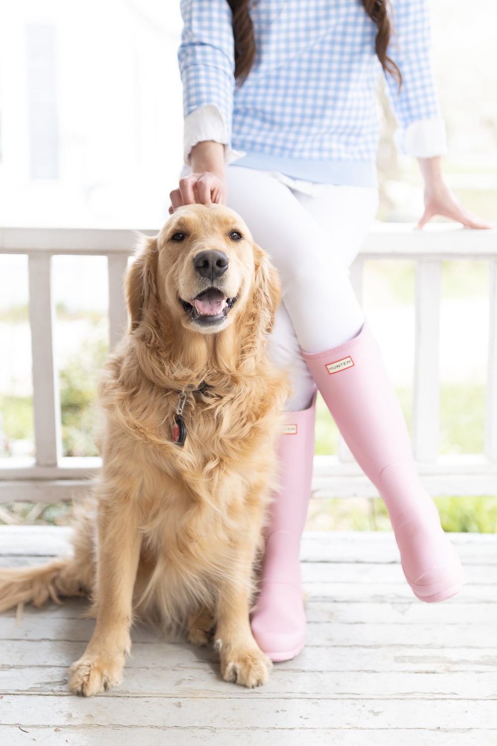 Matte pink Hunter rain boots next to a golden retriever puppy on Diary of a Debutante