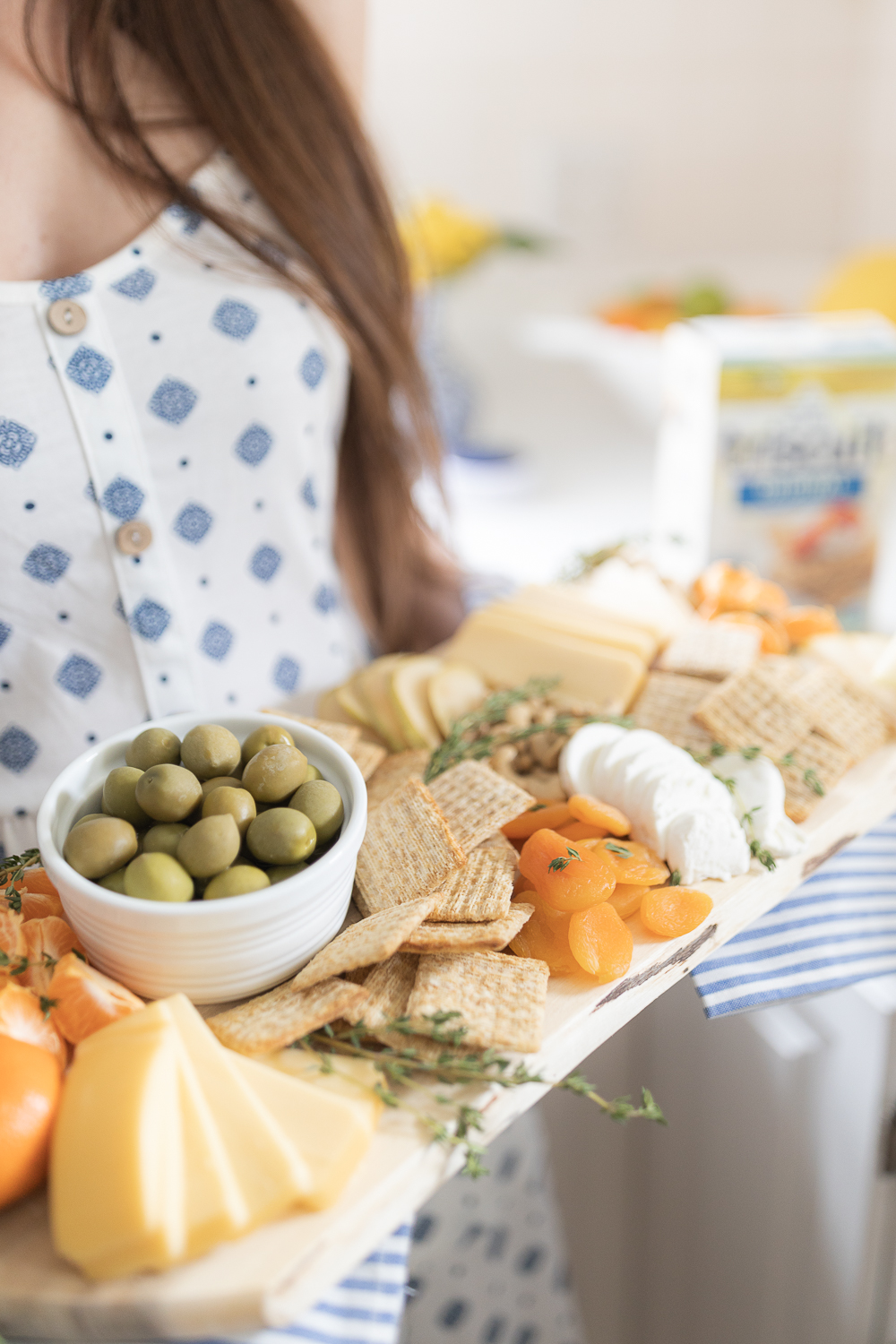 Budget-friendly cheese board recipe featuring Triscuits, Mezzetta Colossal Fancy Green Olives, dried apricots, and other common pantry items by blogger Stephanie Ziajka on Diary of a Debutante