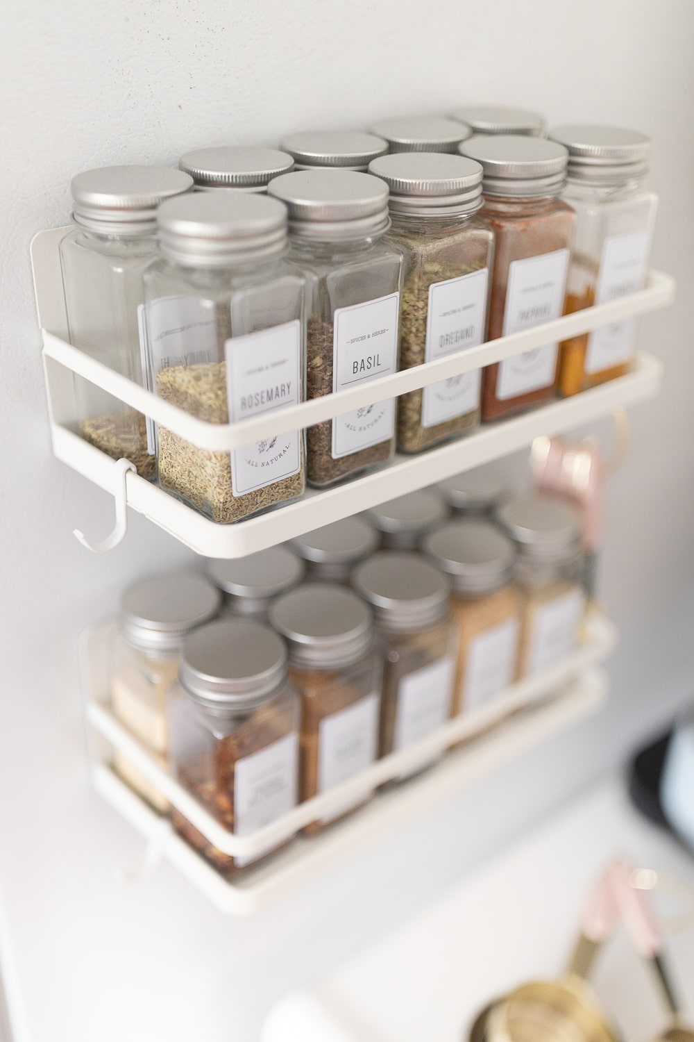 Blogger Stephanie Ziajka shares a magnetic spice jar organization idea for small kitchens on Diary of a Debutante
