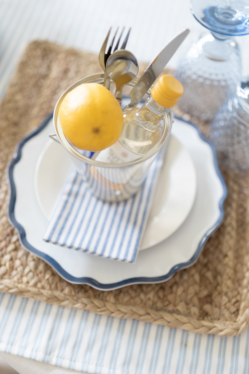 Individual clambake party place settings using clear mini buckets, lemons, and bottles of miniature Sutter Home wine designed by blogger Stephanie Ziajka on Diary of a Debutante